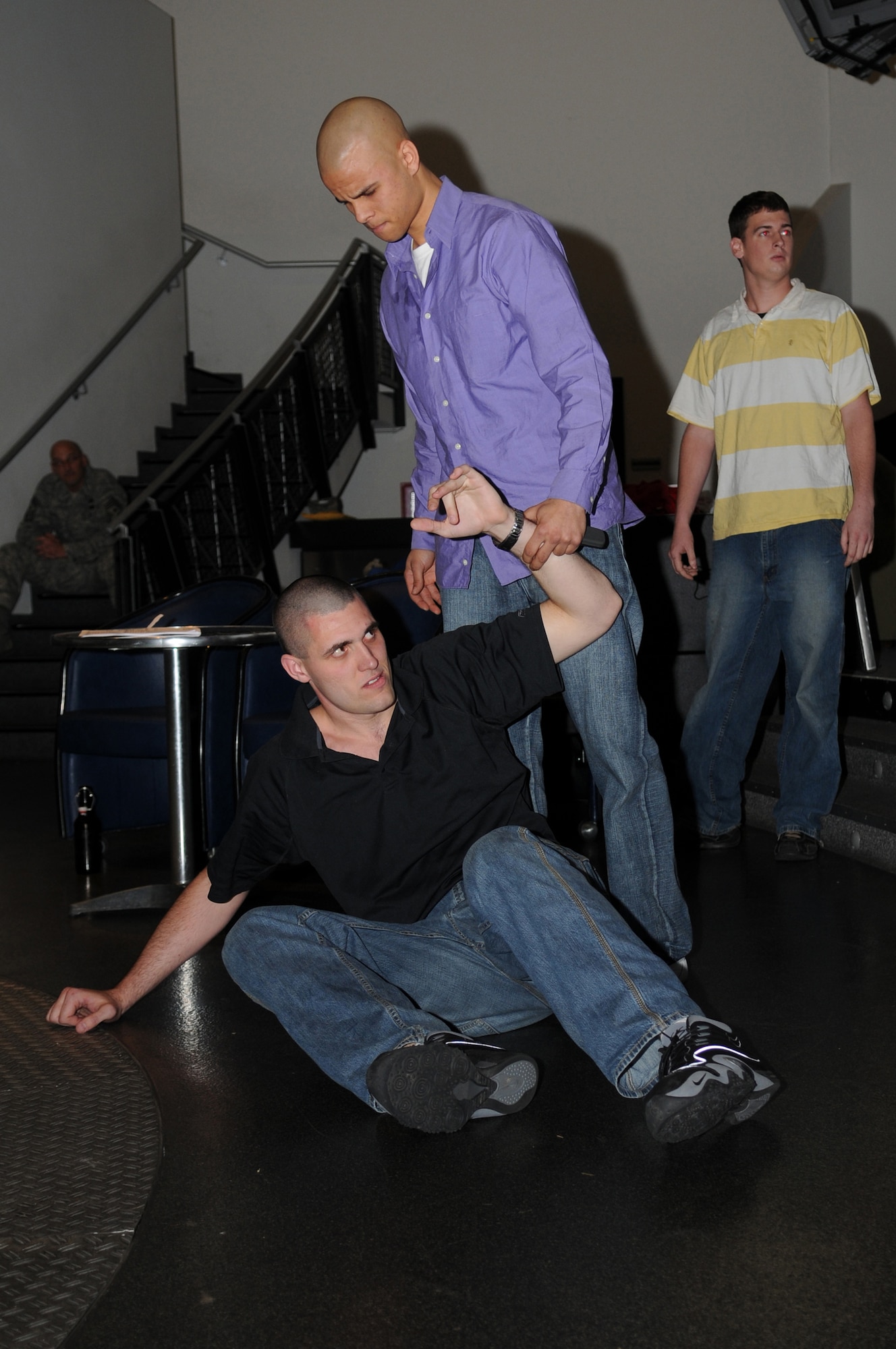 Airman 1st Class Matthew Flowers and Airman 1st Class Jeffrey Huff act out a bar fight scenario, Ramstein Air Base, Germany, Nov. 18, 2008. The scene was held during the Dorm Resident Airman Day meeting to inform others on different types of alcohol related incidents that can occur in the KMC area. (U.S. photo by Airman 1st Class Grovert Fuentes-Contreras)