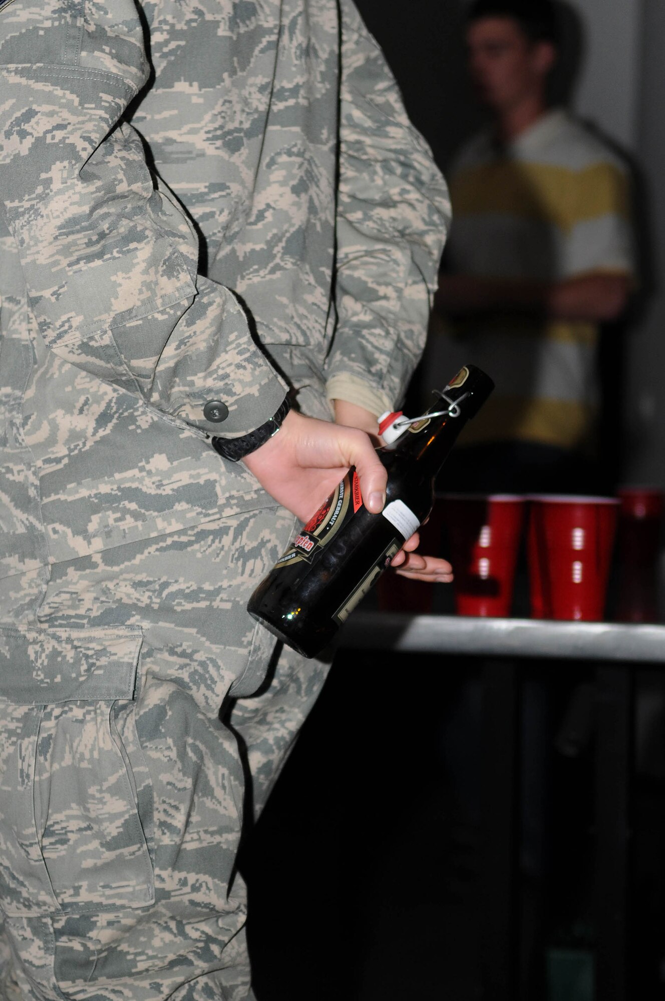 U.S. Air Force Airman pretends she is hiding an alcoholic beverage during an alcohol related incident scene, Ramstein Air Base, Germany, Nov. 18, 2008. The scene was held during the Dorm Resident Airman Day meeting to inform others on different types of ARI that can occur in the KMC area. (U.S. Air Force photo by Airman 1st Class Grovert Fuentes-Contreras)