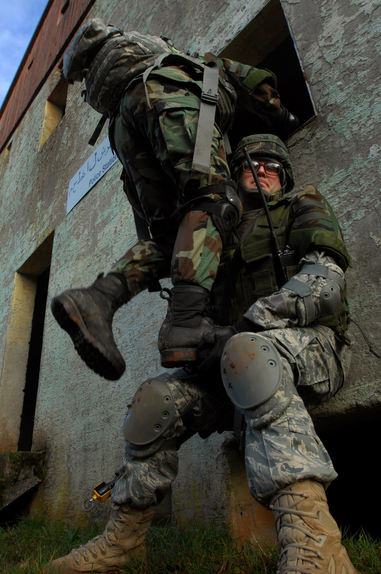 Staff Sgt. Joseph Simon, and Airman 1st Class Yazmine Nash, 423rd Security Forces Squadron, Royal Air Force Alconbury, England, work together to get into the window of a building during urban operations training as a part of a two-week long Creek Defender course, Nov. 17, 2008, Baumholder, Germany. (U.S. Air Force photo by Airman 1st Class Kenny Holston)