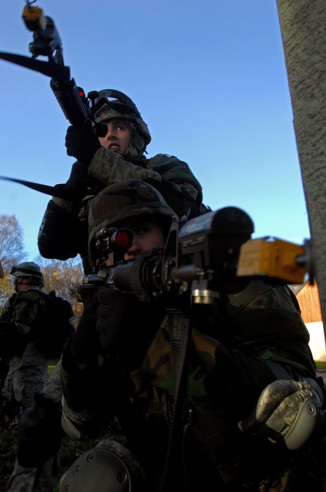 Airman 1st Class Tyler McEuin, and Michael Adams, 423rd Security Forces Squadron, Royal Air Force Alconbury, England, put eyes on target as they come around the corner of a building during urban operations training as a part of a two-week long Creek Defender course, Nov. 17, 2008, Baumholder, Germany. (U.S. Air Force photo by Airman 1st Class Kenny Holston)