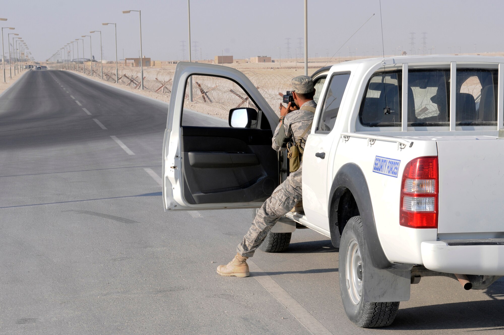 Staff Sgt. Darryl Thompson, 379th Expeditionary Security Forces Squadron, checks the speed of an approaching vehicle with a radar gun, Nov. 22, at an undisclosed air base in Southwest Asia.  Security Forces patrolmen maintain speed limits on base to ensure the safety of all personnel, vehicle operators as well as pedestrians.  Sergeant Thompson, a native of Columbus, Ohio, is deployed from Hill Air Force Base, Utah, in support of Operations Iraqi and Enduring Freedom and Joint Task Force-Horn of Africa.  (U.S. Air Force photo by Tech. Sgt. Michael Boquette/Released)