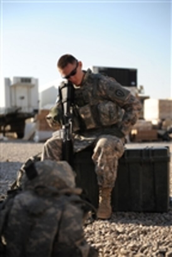 U.S. Army Cpl. David Hea, from 2nd Battalion, 35th Infantry Regiment, 3rd Brigade Combat Team, 25th Infantry Division, takes a short break while waiting for his ride to take him from Patrol Base Olsen to Forward Operating Base Brassfield in Samarra, Iraq, on Nov. 17, 2008.  