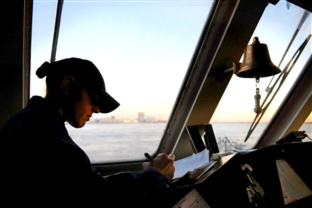 U.S. Navy Lt. j.g. Shaina Hayden, ship's navigator, makes an entry in the deck log while the littoral combat ship USS Freedom gets under way,  Montreal, Canada, Nov. 21, 2008. Freedom is the first of two littoral combat ships designed to operate in shallow water environments to counter threats in coastal regions. The ship was commissioned Nov. 8 in Milwaukee and will make port calls while on its way to Norfolk, Va.