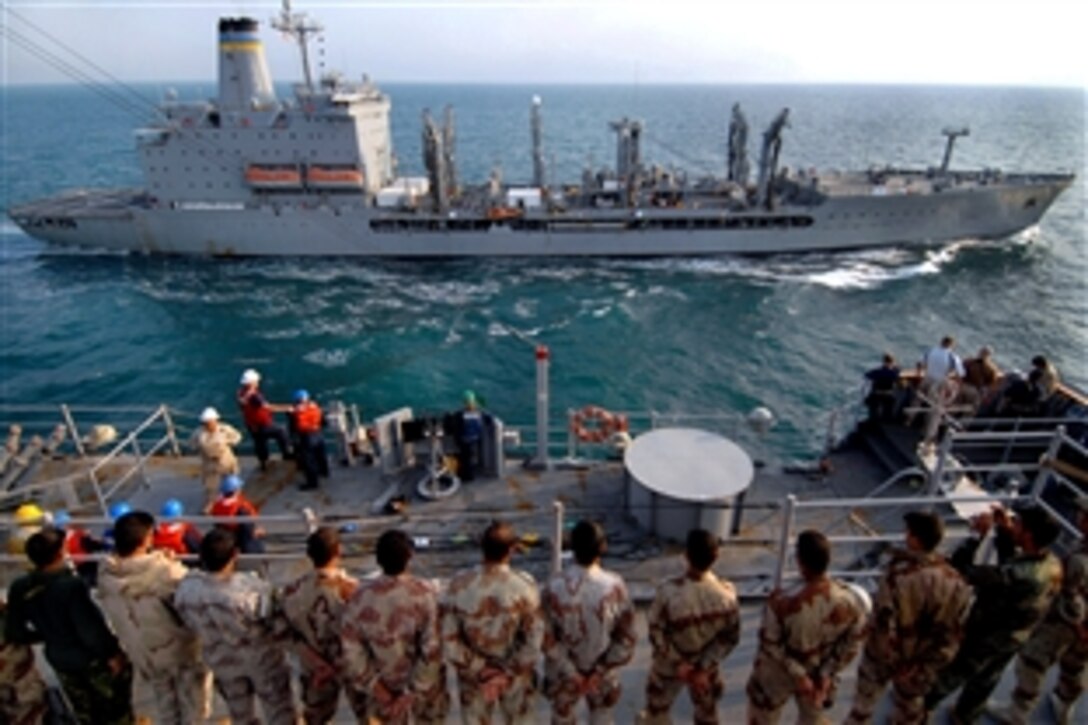 Iraqi sailors and U.S. Marines observe as the USNS Tippecanoe pulls alongside the amphibious dock landing ship USS Carter Hall for a replenishment at sea in the Persian Gulf, Nov. 11, 2008. Carter Hall is deployed as part of the Iwo Jima Expeditionary Strike Group supporting maritime security operations in the U.S. 5th Fleet area of responsibility. 