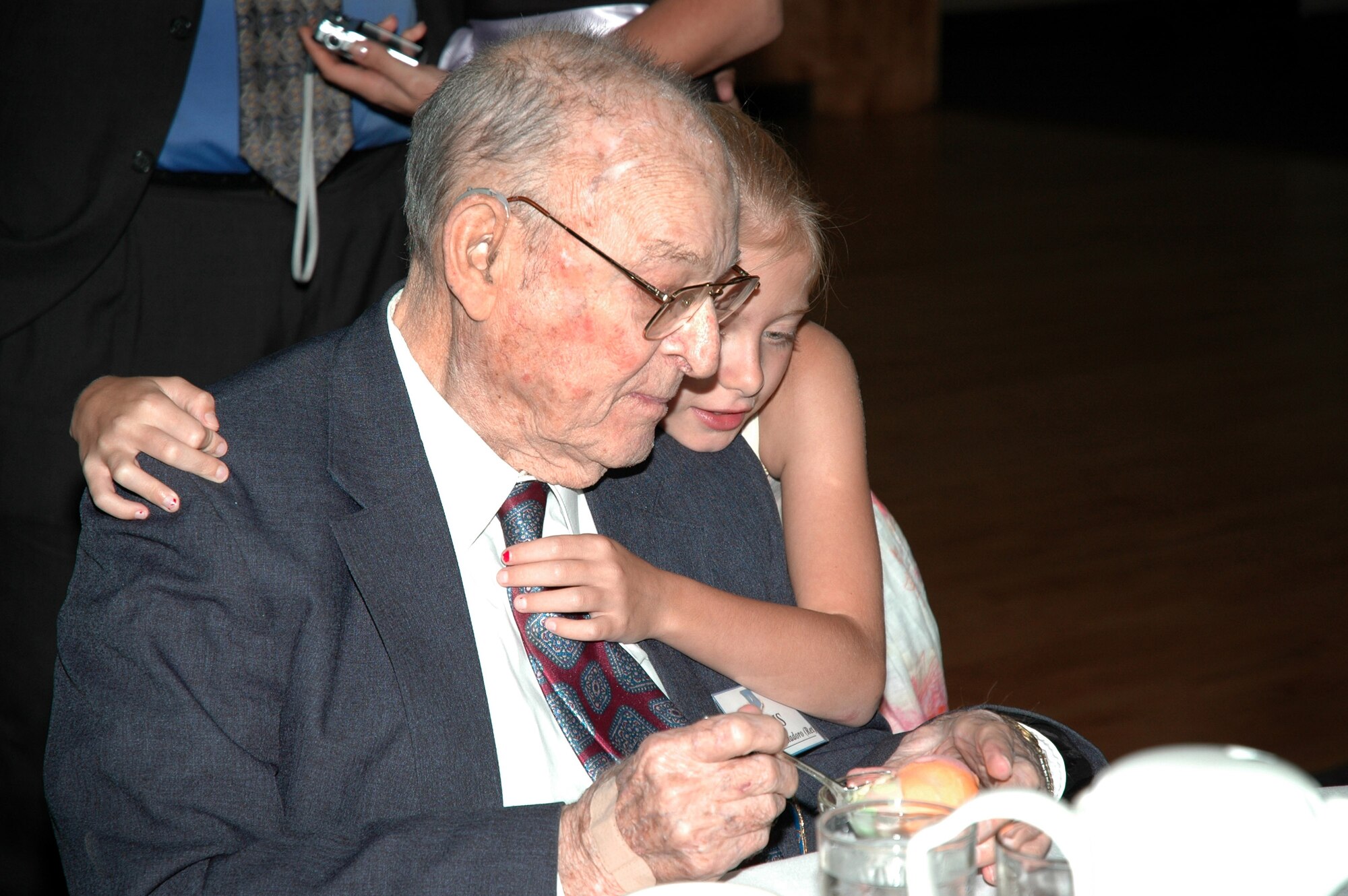 Retired Brig. Gen. Maurice Cristodoro gets a hug from a family member Aug.24, 2006, just before he is inducted into the Air Force Space and Missile Pioneers Hall of Fame at Peterson Air Force Base, Colo. (U.S. Air Force photo/Tech. Sgt. Kate Rust)