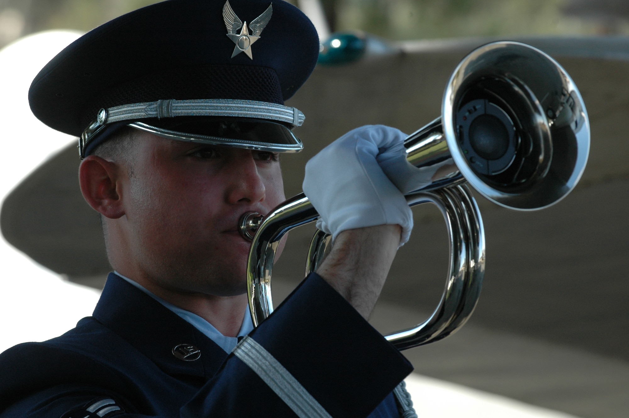Airman 1st Class Chirstopher Jannette from the Travis Honor Guard simulates playing taps during a full honors funeral demonstration following USAF Honor Guard Training Team training. (U.S. Air Force photo/Staff Sgt. Shaun Emery)