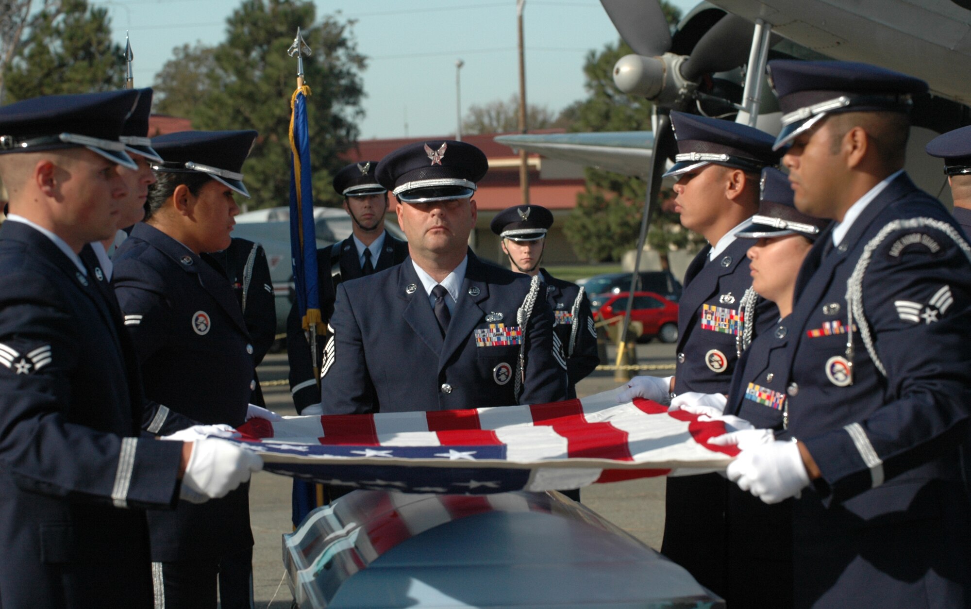 Members of the Travis Air Force Base Honor Guard prepare to fold the flag during a full honors funeral demonstration. (U.S. Air Force photo/Staff Sgt. Shaun Emery)