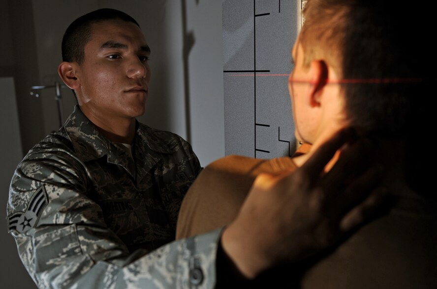 (Left) Senior Airman David Whiting, 28th Medical Support Squadron diagnostic imaging technician, positions a patient before X-raying at the 28th Medical Group here, Nov. 25. This position is used to X-ray the lateral sinus. (U.S. Air Force photo/Senior Airman Marc I. Lane)