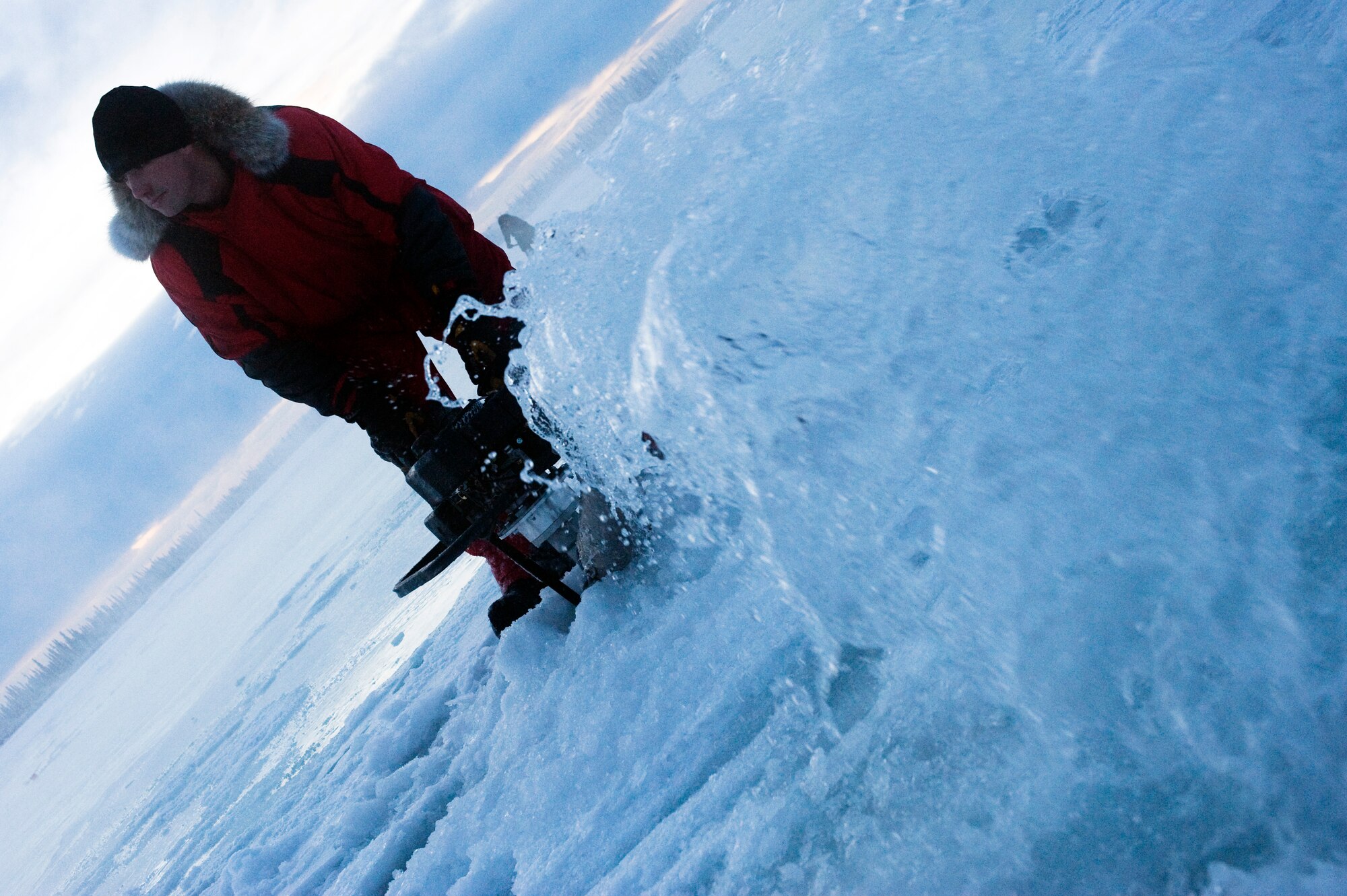 Tech. Sgt. Tim Broderick pumps water from the Tanana River to build up the ice thickness Nov. 24, 2008, at Fairbanks, Alaska. The ice bridge takes six to 10 weeks to complete in sub-zero weather. It is five-feet deep, 32 miles long and capable of supporting more than 110 tons -- and will melt back into the river when spring thaw hits. The ice bridge enables 354th CES Airmen to access and perform annual maintenance at Blair Lakes Bombing Range. Sergeant Broderick is assigned to the 354th Civil Engineer Squadron range maintenance.  (U.S. Air Force photo/Senior Airman Jonathan Snyder)