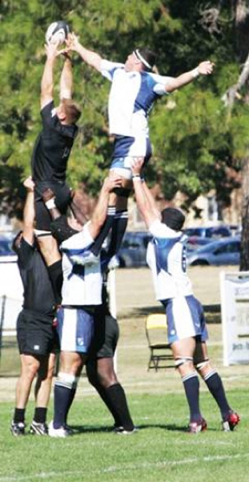FORT BENNING, Ga. -- Army (in black) and Air Force rugby team players attempt to gain possession of the ball on an inbound throw during the first match of the 2008 Armed Forces Rugby Championships. The Air Force won the matchup 44-3. (U.S. Army photo/John Peeler)