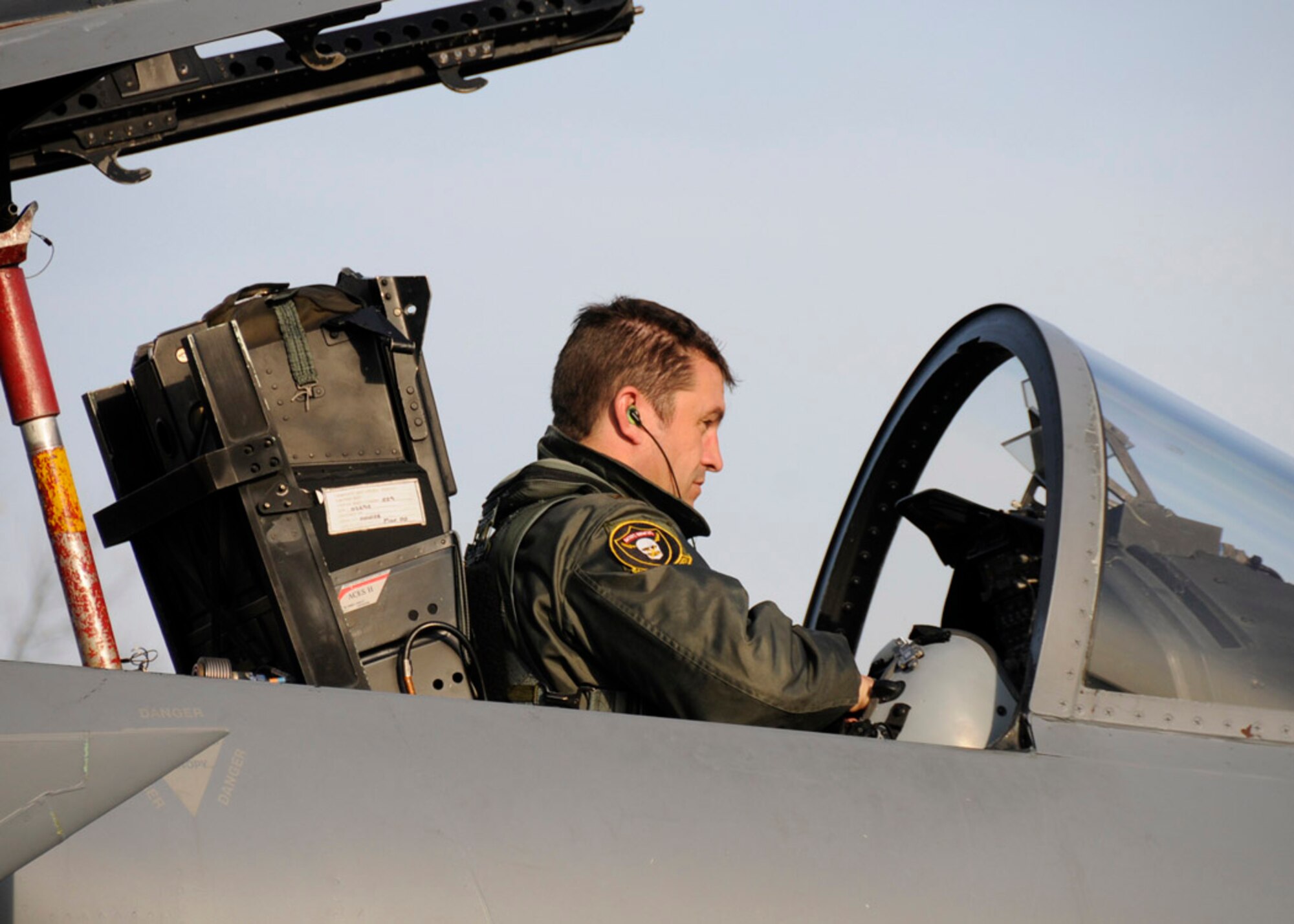Maj. David Pryor removes his helmet after a mock scramble Nov. 11 in Siauliai, Lithuania. The pilots stay on alert status 24 hours a day, seven days a week, to support the NATO Baltic air policing mission. Major Pryor is a 493rd Expeditionary Fighter Squadron pilot. (U.S. Air Force photo)
