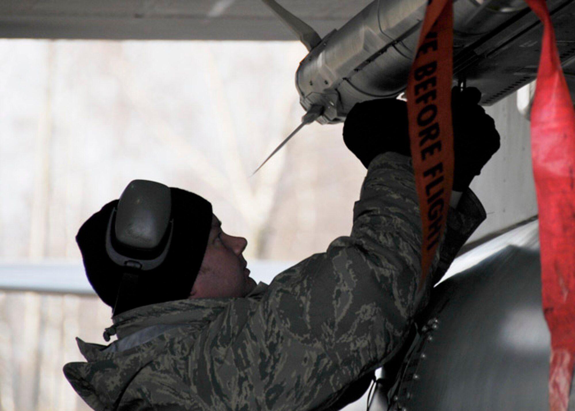 Staff Sgt. Kristopher Glenn inspects the missiles on an F-15 Eagle after landing Nov. 11 at Siauliai, Lithuania. Sergeant Glenn ensures the weapons are secured to the aircraft and makes any necessary adjustments due to movement in flight. He is a 493rd Expeditionary Fighter Squadron weapons loader. (U.S. Air Force photo) 
