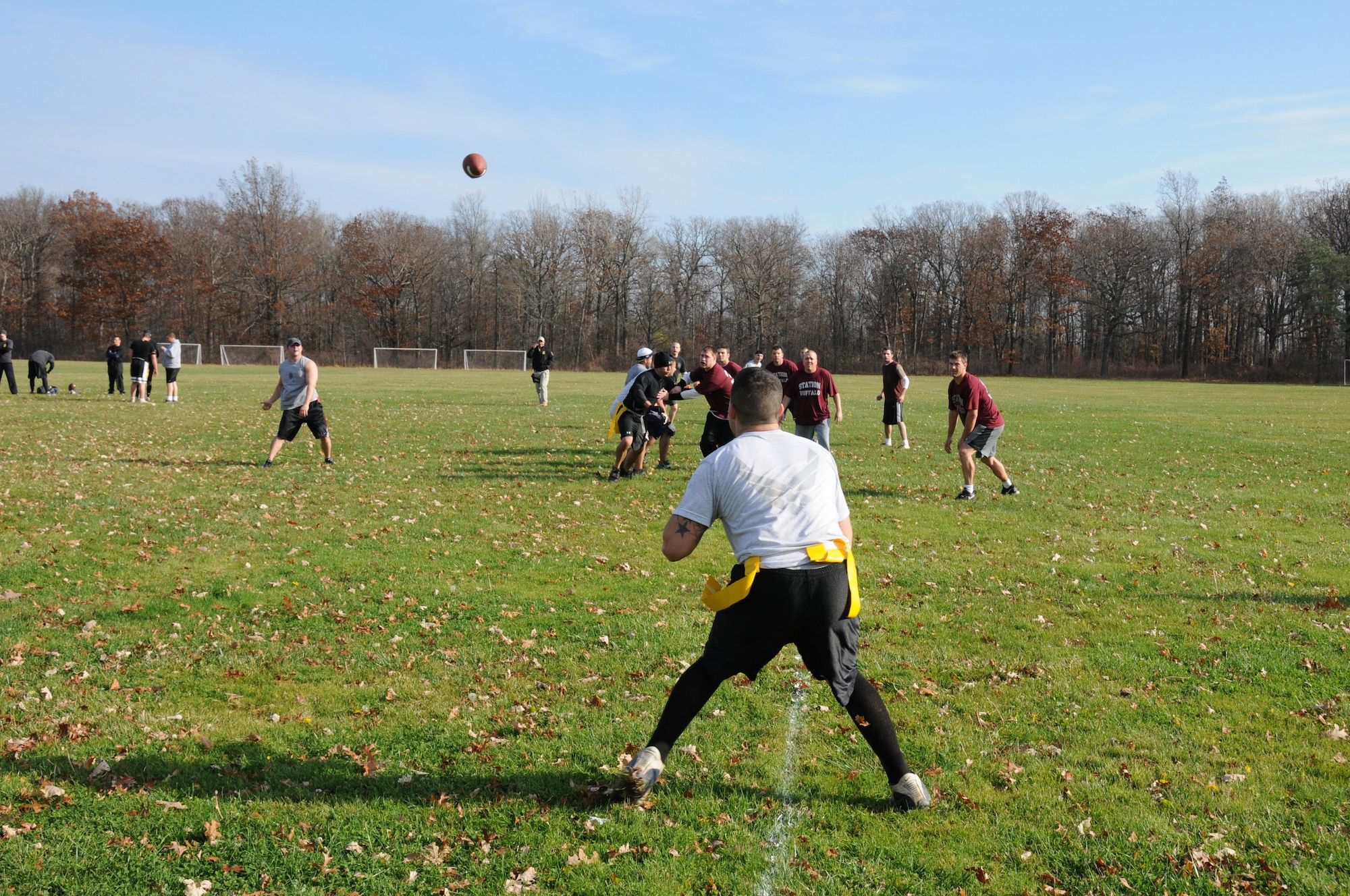 Master Sgt. Jason Folckemer throttles the pig skin into the hands of Senior Airman Michael Badolato the play resulted in a touch down for the 107th Airlift Wing, Security Forces Squadron. The squadron spent their day at Fort Niagara State Park play in the Toys for Tots Flag Football Tournament. U.S. Air Force photo/Senior Airman Peter Dean