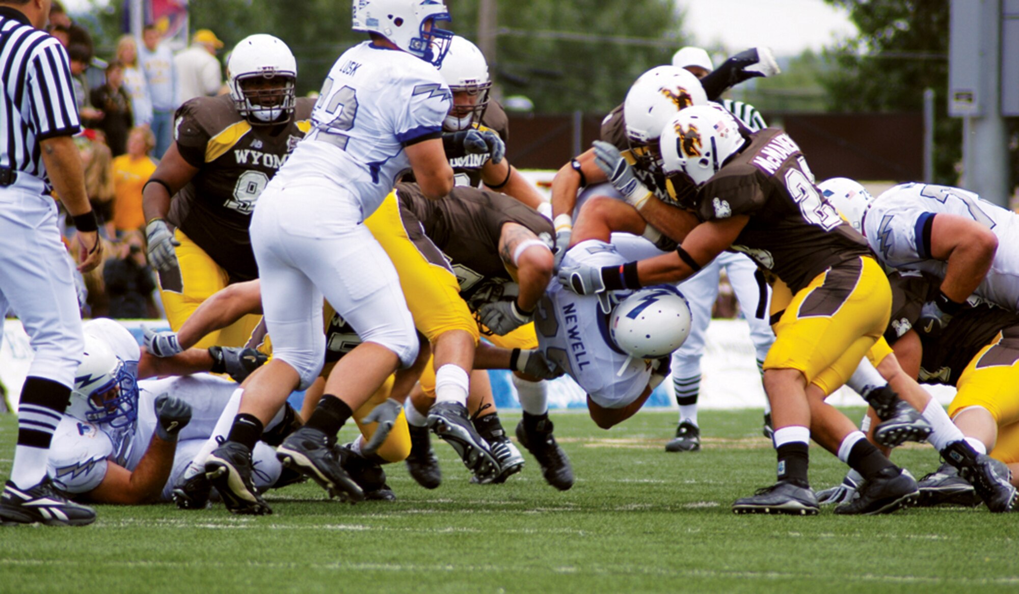 Air Force Falcon's Stephen Newell hits the University of Wyoming Cowboys' line early in the game at the War Memorial Stadium in Laramie, Wyo., Sept. 6. The Pokes hung tough for one half before folding like a card table as the Falcons won the game 23 to 3 (U.S. Air Force photo/Airman 1st Class Daryl Knee).
