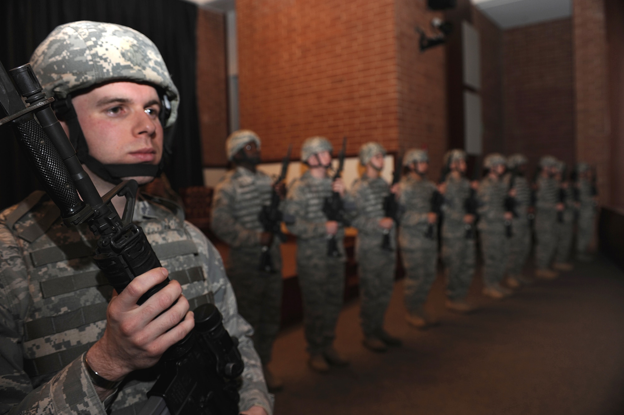 Security forces Airmen from the U.S. Air Force Expeditionary Center stand in a formation of more than 20 during the Order of the Bayonet induction ceremony Nov. 24, 2008 for Master Sgt. Jason Parker in the USAF EC's Grace Peterson Hall on Fort Dix, N.J.  Sergeant Parker, now stationed at the 92nd Security Forces Squadron at Fairchild Air Force Base, Wash., was nominated for the award while serving as a member of the Expeditionary Center's 421st Combat Training Squadron.  (U.S. Air Force Photo/Staff Sgt. Nathan Bevier)