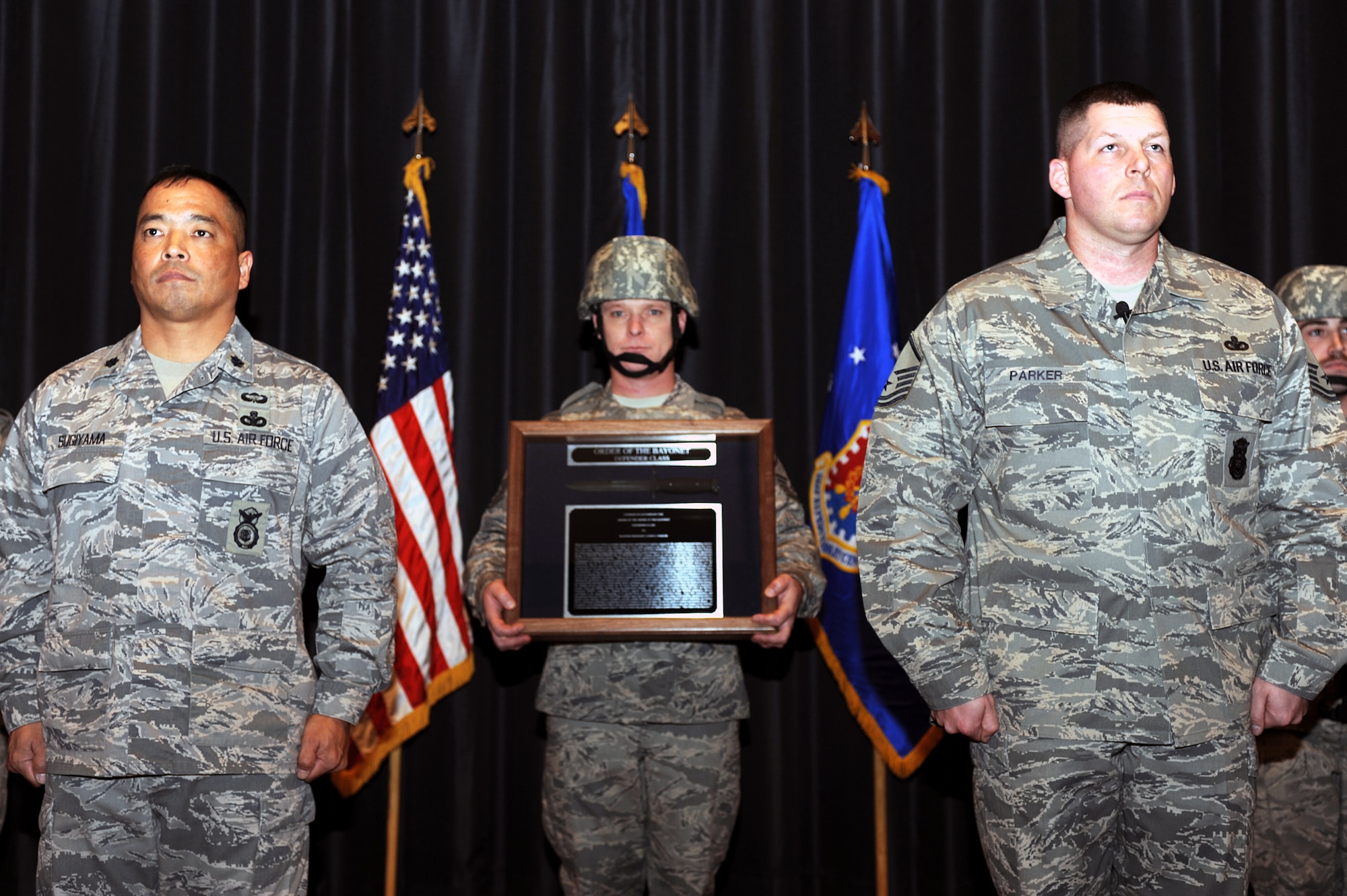 Lt. Col. Steve Sugiyama and Master Sgt. Jason Parker stand at attention during the reading of the citation and the presentation of the award of the Order of the Bayonet for Sergeant Jason Parker in the U.S. Air Force Expeditionary Center's Grace Peterson Hall on Fort Dix, N.J.  Sergeant Parker, now stationed at the 92nd Security Forces Squadron at Fairchild Air Force Base, Wash., was nominated for the award while serving as a member of the Expeditionary Center's 421st Combat Training Squadron. Colonel Sugiyama is the deputy commandant of the USAF EC's Expeditionary Operations School.  (U.S. Air Force Photo/Staff Sgt. Nathan Bevier)