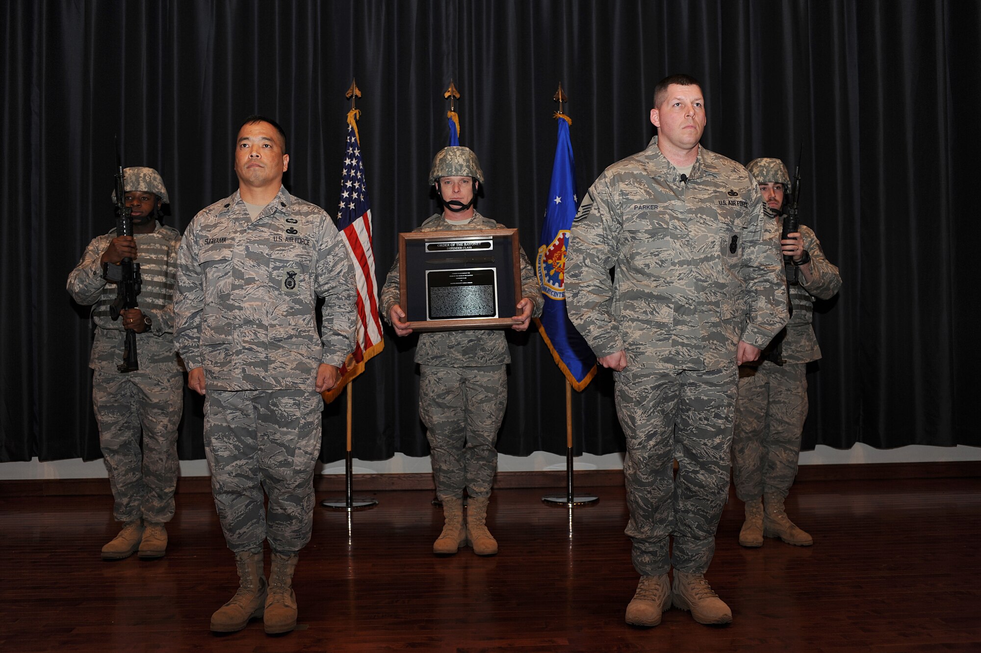 Lt. Col. Steve Sugiyama and Master Sgt. Jason Parker stand at attention during the reading of the citation and the presentation of the award of the Order of the Bayonet for Sergeant Jason Parker in the U.S. Air Force Expeditionary Center's Grace Peterson Hall on Fort Dix, N.J.  Sergeant Parker, now stationed at the 92nd Security Forces Squadron at Fairchild Air Force Base, Wash., was nominated for the award while serving as a member of the Expeditionary Center's 421st Combat Training Squadron. Colonel Sugiyama is the deputy commandant of the USAF EC's Expeditionary Operations School.  (U.S. Air Force Photo/Staff Sgt. Nathan Bevier)