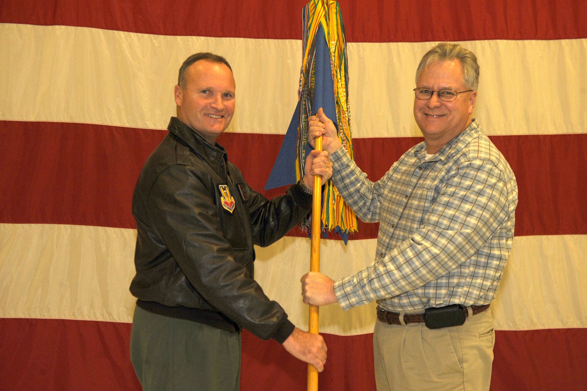 MOUNTAIN HOME AIR FORCE BASE, Idaho -- Left, Col. James Browne, 366th Fighter Wing commander, inducts John Marshall into the wing’s honorary commander program Nov. 14. Mr. Marshall, Radio Shack owner and freelance media professional, will serve as Colonel Browne’s honorary commander. Now entering its third year, the program fosters key partnerships between base and community leaders showcasing the base’s unique and vital mission. It also offers an opportunity for wing leadership to recognize important issues and concerns beyond the base gates. (U.S. Air Force photo/ Airman 1st Class Stephany Miller)