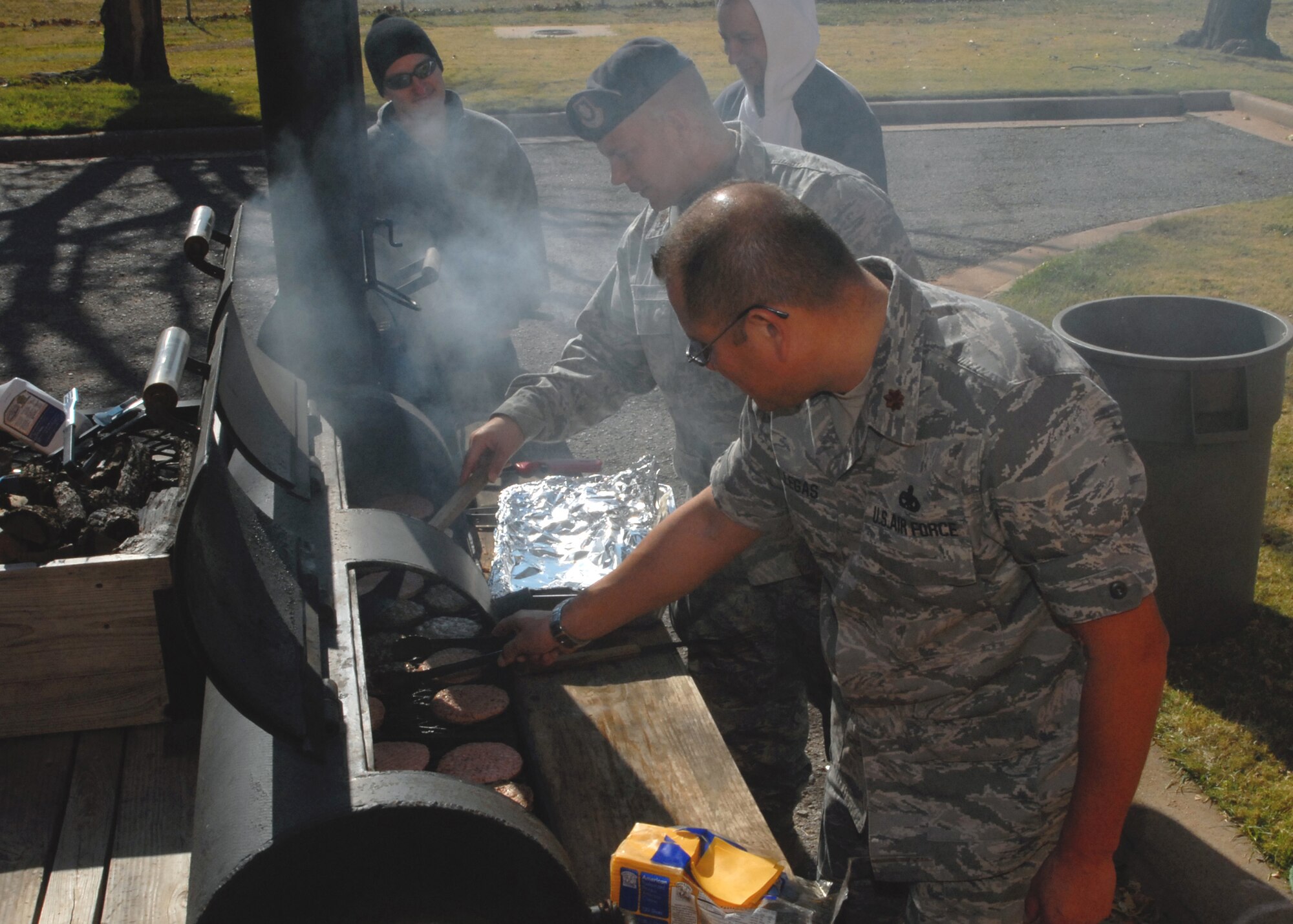 Maj. William Villegas, front, of the 982nd Maintenance Squadron, and 82nd Security Forces Squadron Commander Maj. William Lowery get some burgers going on the grill Nov. 21 at the South Chapel during an honor guard cookout. The cookout gave Sheppard leadership an opportunity to thank the men and women of the honor guard for their diligence and support of events ranging from changes of command to military funerals. (U.S. Air Force photo/Lou Anne Sledge)