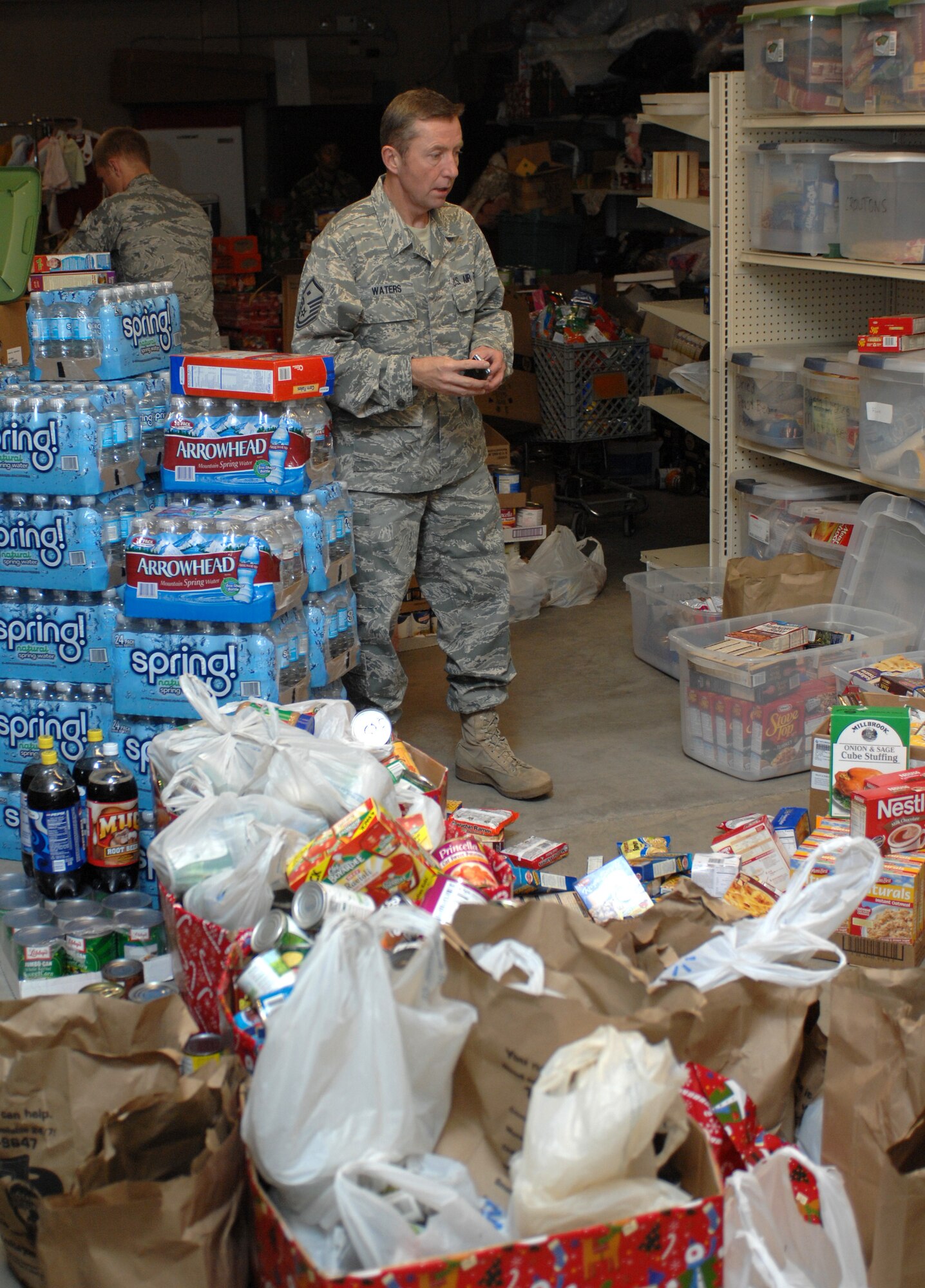 MOUNTAIN HOME AIR FORCE BASE, Idaho -- Master Sgt.  Jeffrey Waters, 366th Equipment Maintenance Squadron first sergeant, stands in the middle of the first sergeants’ food locker surrounded by the food donated from the 366th Logistic Readiness Squadron's food drive Nov. 18. The Operation Warm Heart food drive became a competition between the flights of the 366th LRS with the POL flight coming in first place with a total of 7,800 pounds donated. All together the 366th LRS donated 11,980 pounds of food. (U.S. Air Force photo/ Airman Debbie Lockhart)