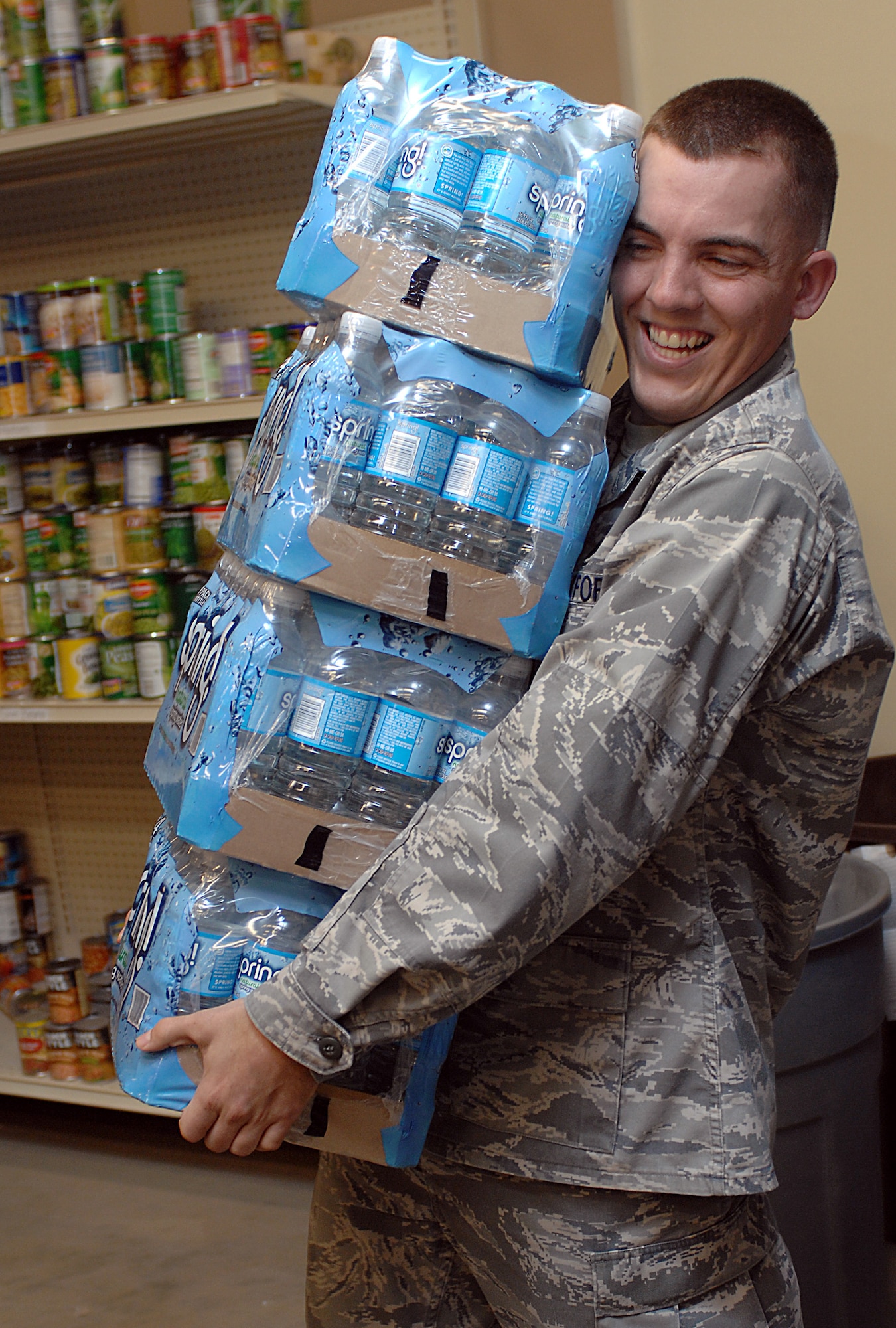 MOUNTAIN HOME AIR FORCE BASE, Idaho -- 1st Lt. Andrew Gordon, 366th Logistics Readiness Squadron, petroleum, oils and lubricants flight, carries donated water into the first sergeants food locker from the 366th LRS food drive Nov. 18. The Operation Warm Heart food drive became a competition between the flights of the 366th LRS with the POL flight coming in first place with a total of 7,800 pounds donated. All together the 366th LRS donated 11,980 pounds of food. (U.S. Air Force photo/ Airman Debbie Lockhart)