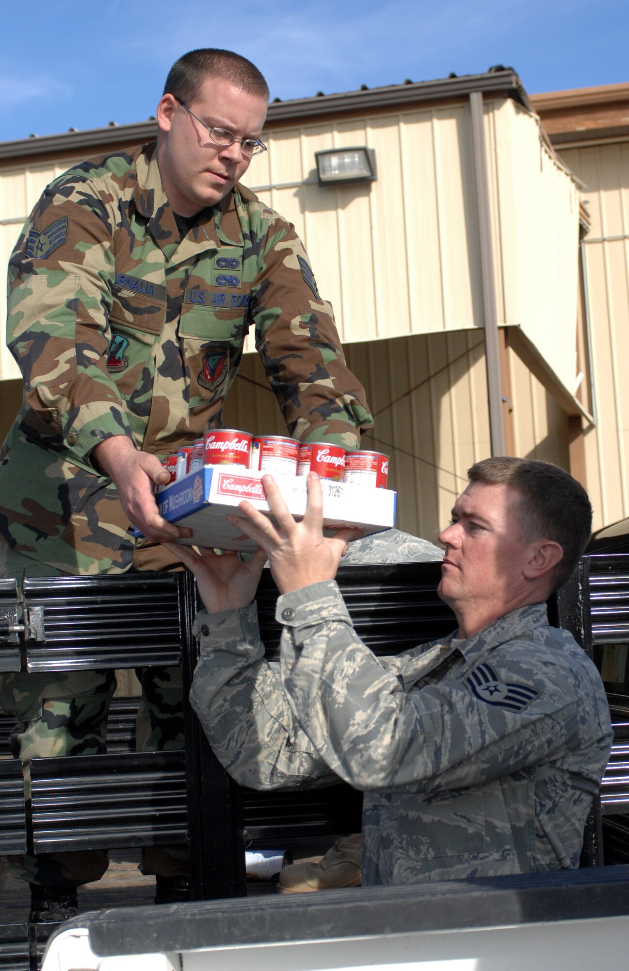 MOUNTAIN HOME AIR FORCE BASE, Idaho -- Staff Sgt. Christopher Curnalia and Staff Sgt. Brian Harris, both 366th Logistic Readiness Squadron, petroleum, oils and lubricants flight, transport donated canned food to the first sergeants' food locker from the 366th LRS food drive Nov. 18. The Operation Warm Heart food drive became a competition between the flights of the 366th LRS with the POL flight coming in first place with a total of 7,800 pounds donated. All together the 366th LRS donated 11,980 pounds of food. (U.S. Air Force photo/ Airman Debbie Lockhart)