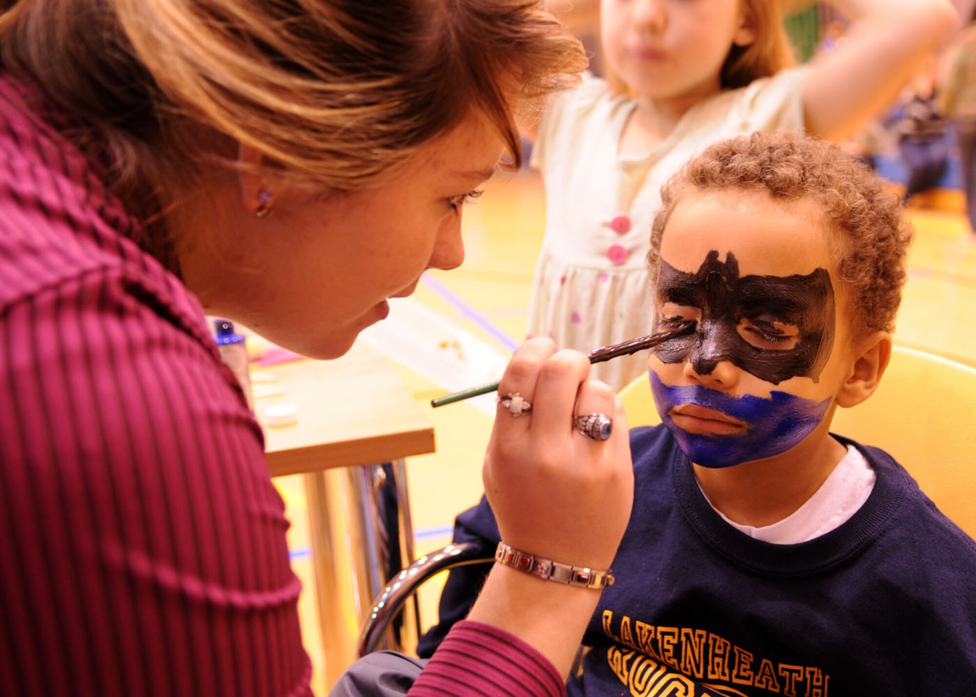 Youth Center volunteer Tabatha Pinckney, paints the face of 5-year-old Andrew O’Connor, son of Staff Sgt. Lachantille O’Connor, from the 352nd Special Operations Group, during “Family Fun Night” at the Youth Center Nov. 21, 2008. The event was held to get families together for a night of fun. (U.S. Air Force photo by Staff Sgt. Jerry Fleshman)