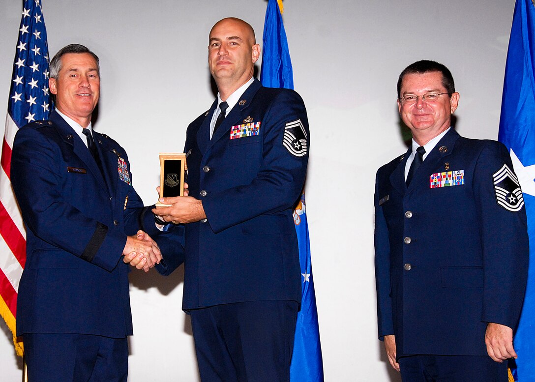 Senior Master Sgt. James Pritchard, center, of the 782nd Training Group accepts the Senior NCO of the Quarter award from Brig. Gen. O.G. Mannon, 82nd Training Wing commander, Nov. 20 during the Quarterly Tech Training Awards in the base theater. Also pictured is Chief Master Sgt. Michael Crowley, right, superintendent of the 882nd TRG. (U.S. Air Force photo/Harry Tonemah)