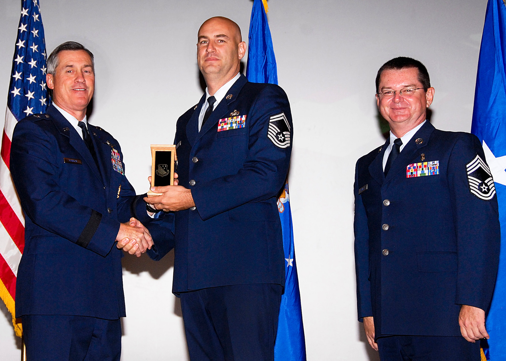 Senior Master Sgt. James Pritchard, center, of the 782nd Training Group accepts the Senior NCO of the Quarter award from Brig. Gen. O.G. Mannon, 82nd Training Wing commander, Nov. 20 during the Quarterly Tech Training Awards in the base theater. Also pictured is Chief Master Sgt. Michael Crowley, right, superintendent of the 882nd TRG. (U.S. Air Force photo/Harry Tonemah)