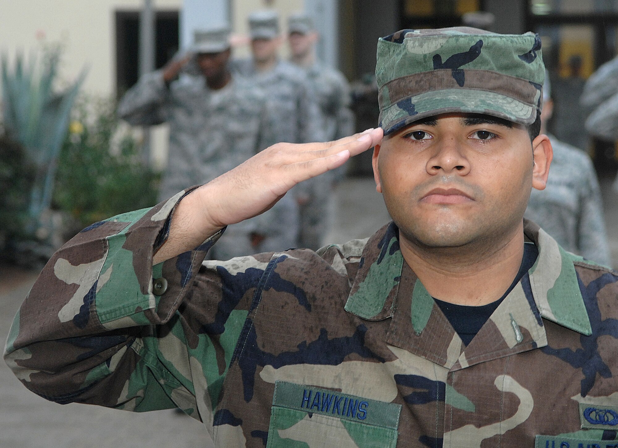 Senior Airman Steven Hawkin, 39th Operations Support Squadron, salutes the American flag as it is raised suring a reveille ceremony performed by Incirlik Airman Leadership School Airmen Nov. 25. ALS prepares and trains future noncomissioned officers for their increased responsibilites. (Photo by Senior Airman Erica Stewart)