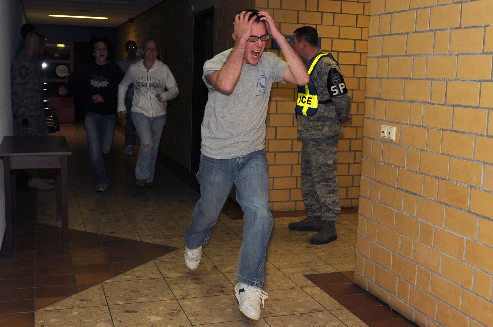Exercise participants, 569th U.S. Forces Police Squadron act as distressed students during a school shooter exercise, Vogelweh Air Base, Germany Nov. 15. The purpose of the exercise was to prepare the 569th USFPS, Polizei, and school personnel in tactics and procedures used during a school shooting. (U.S. Air Force photo by Senior Airman Kelly LeGuillon)