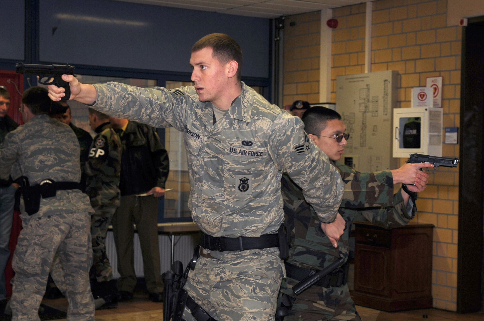 Members of the special reaction team, 569th U.S. Forces Police Squadron practice close quarter battle techniques to neutralize the threat during a school shooter exercise, Vogelweh Air Base, Germany Nov. 15. The purpose of the exercise was to prepare the 569th USFPS, Polizei, and school personnel in tactics and procedures used during a school shooting. (U.S. Air Force photo by Senior Airman Kelly LeGuillon)