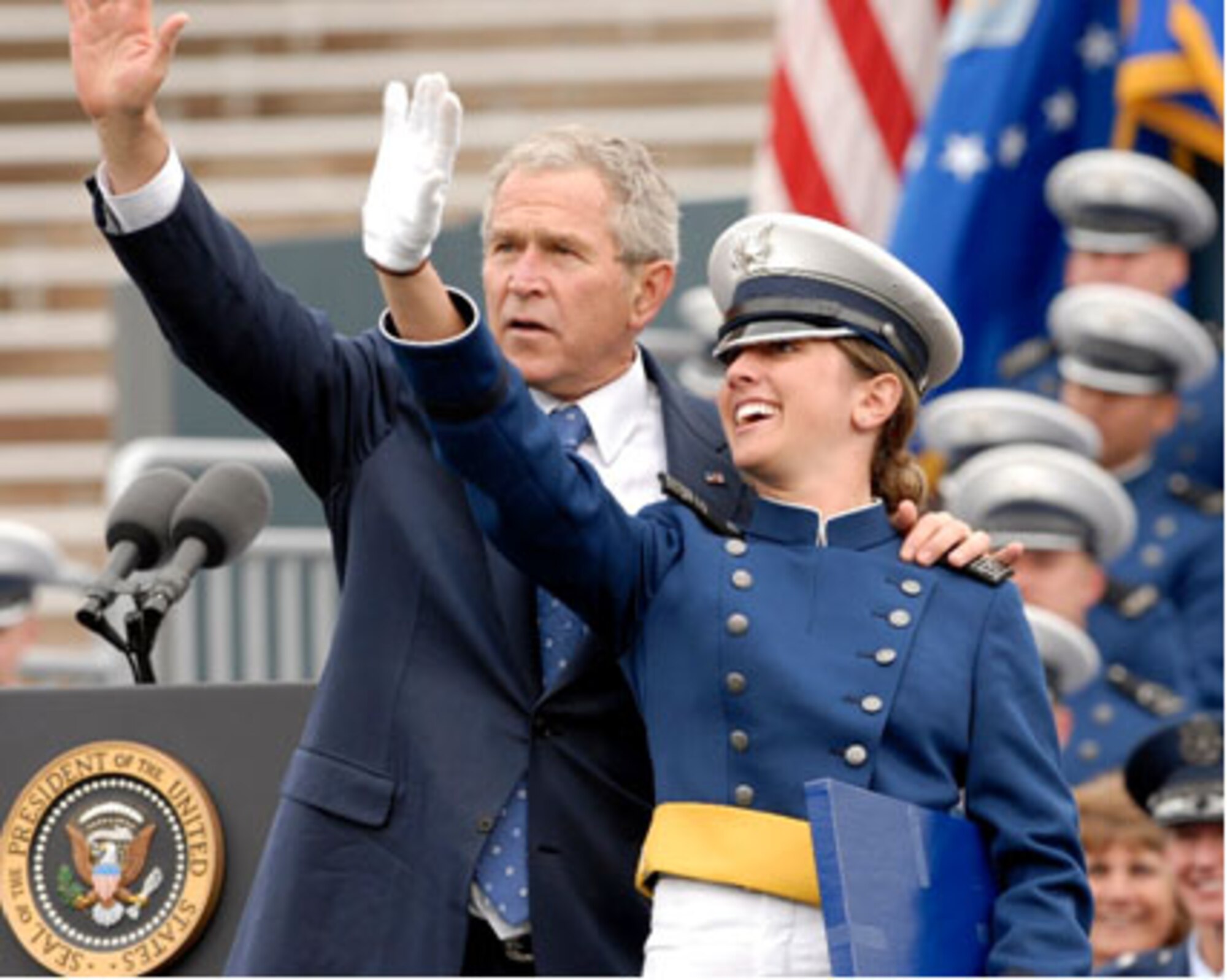 President George W. Bush and 2nd Lt.  Katie Newkirk, 501st Combat Support Wing, Royal Air Force Alconbury, United Kingdom, wave to audience members attending the U.S. Air Force Academy graduation May 2008.  Lieutenant Newkirk was a former enlisted Airman who was selected to attend the Air Force Academy and later commissioned through the Leaders Encouraging Airmen Development program.  (Courtesy Photo) 