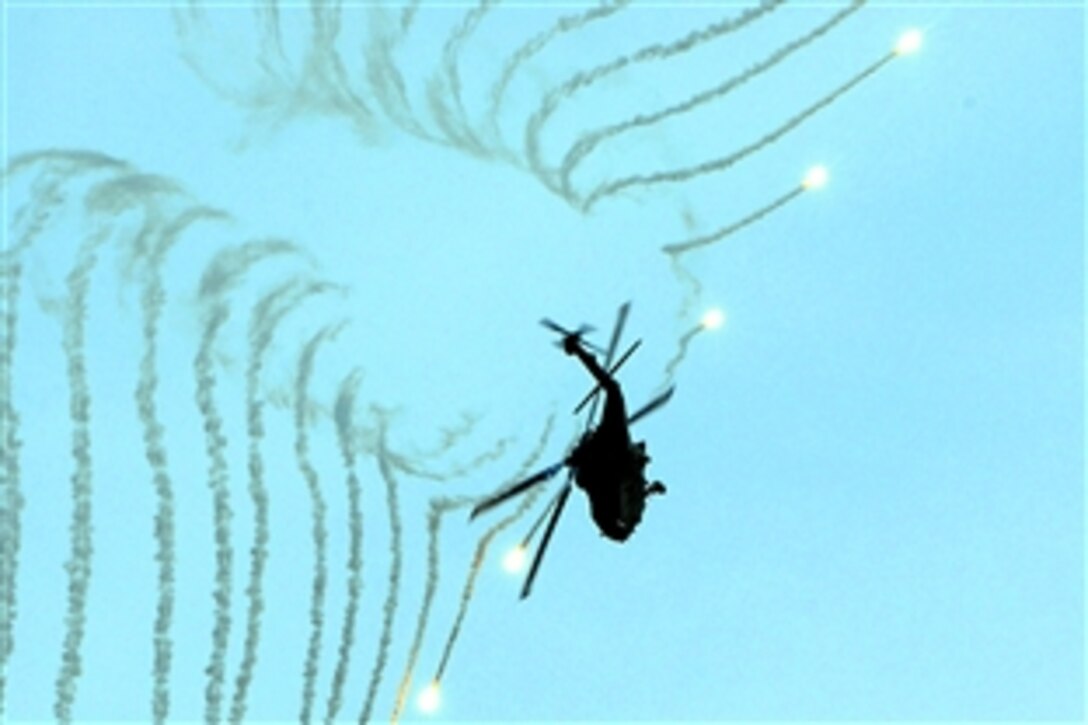 An HH-60H Seahawk assigned to the "Black Knights" of Helicopter Anti-Submarine Squadron 4 displays the ability to launch flares and quickly maneuver out of a vulnerable position during an air power demonstration alongside the Nimitz-class aircraft carrier USS Ronald Reagan in the Pacific Ocean, Nov. 21, 2008. The Ronald Reagan is on a scheduled deployment operating in the U.S. 3rd Fleet area of operations.