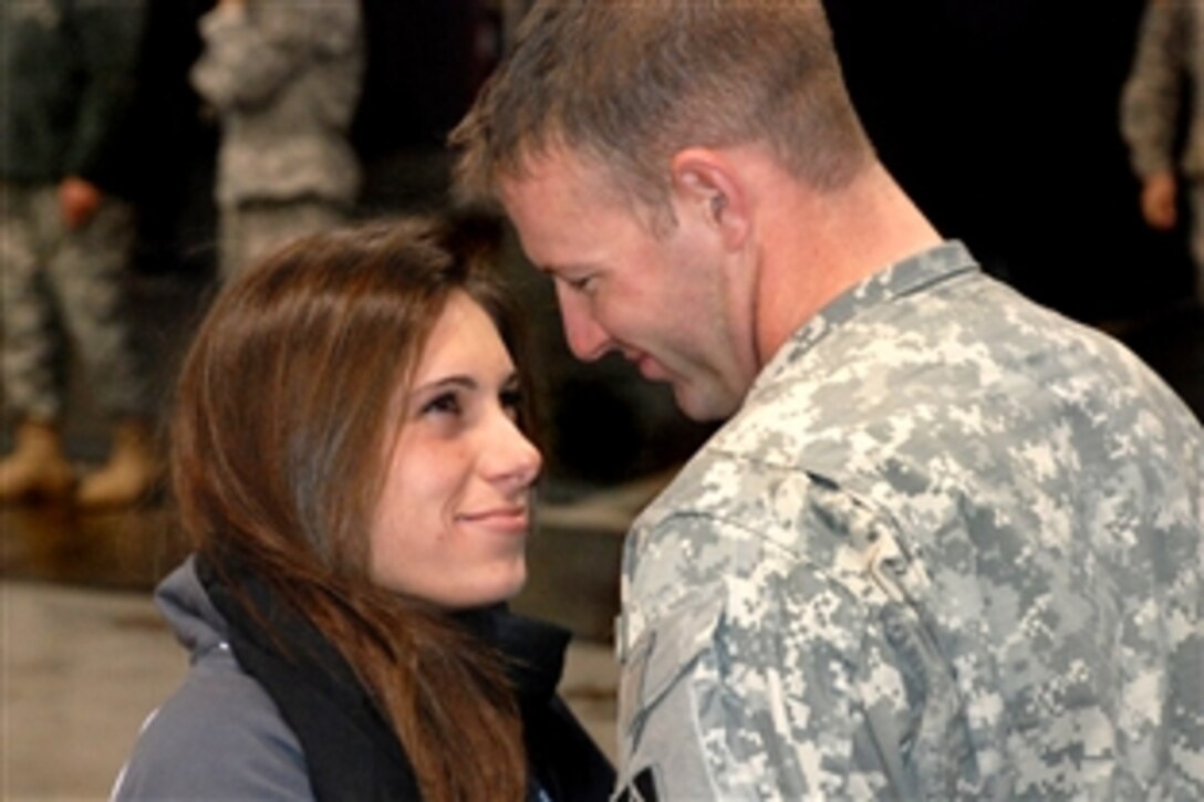 Indiana National Guard 1st Lt. Timothy J. Halls smiles at his fiancé Mylana Haydu after returning from a nine-month deployment to Iraq, Nov. 22, 2008. Halls is assigned to Company B, 1st Battalion, 151st Infantry Regiment based in Martinsville, Ind.