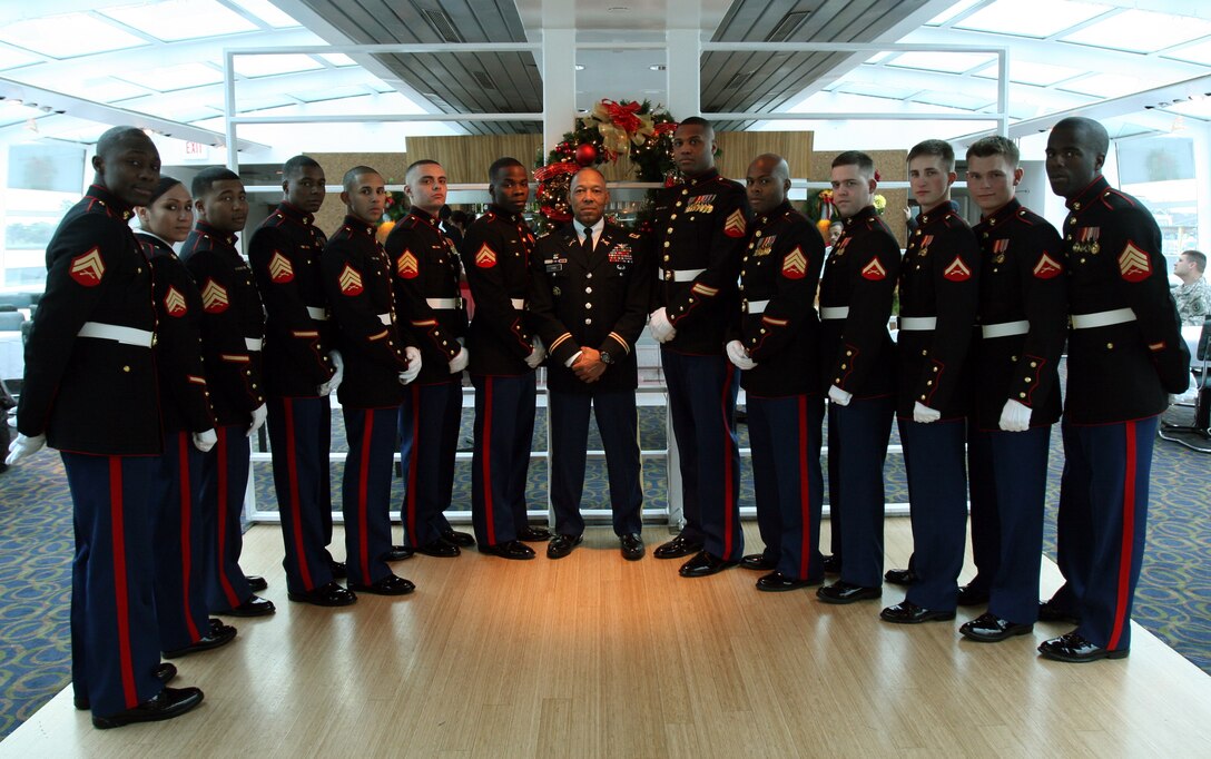 Lt. Col Michael R. Ford, Army National Guard Aviation and Safety Division, stands with devil dogs from Marine Barracks Washington after a Thanksgiving celebration aboard the Odyssey III, Nov. 25.