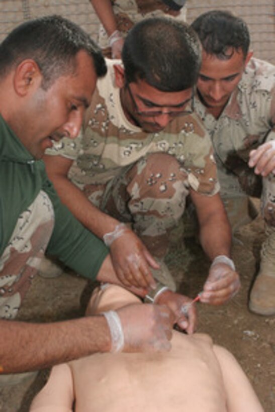 Iraqi Soldiers apply an intravenous needle to a simulated patient during the Combat Lifesaver Course here, Nov. 25. Thirty-two Iraqi Soldiers graduated from the two-day course that was taught using media presentations and hands-on training. At the end of the second day, the Iraqi Soldiers took the final exam, which consisted of four common combat scenarios. They had to assess their patient and provide immediate medical care while being evaluated on their skills. "By teaching the CLS course, we're helping the Iraqi Army take one step closer in being able to operate on their own," said Cpl. Jose C. Lopez, 28, from Bronx, N.Y., a motor transportation operator with STP, 1st Maint. Bn. (-) (Rein.), 1st MLG.