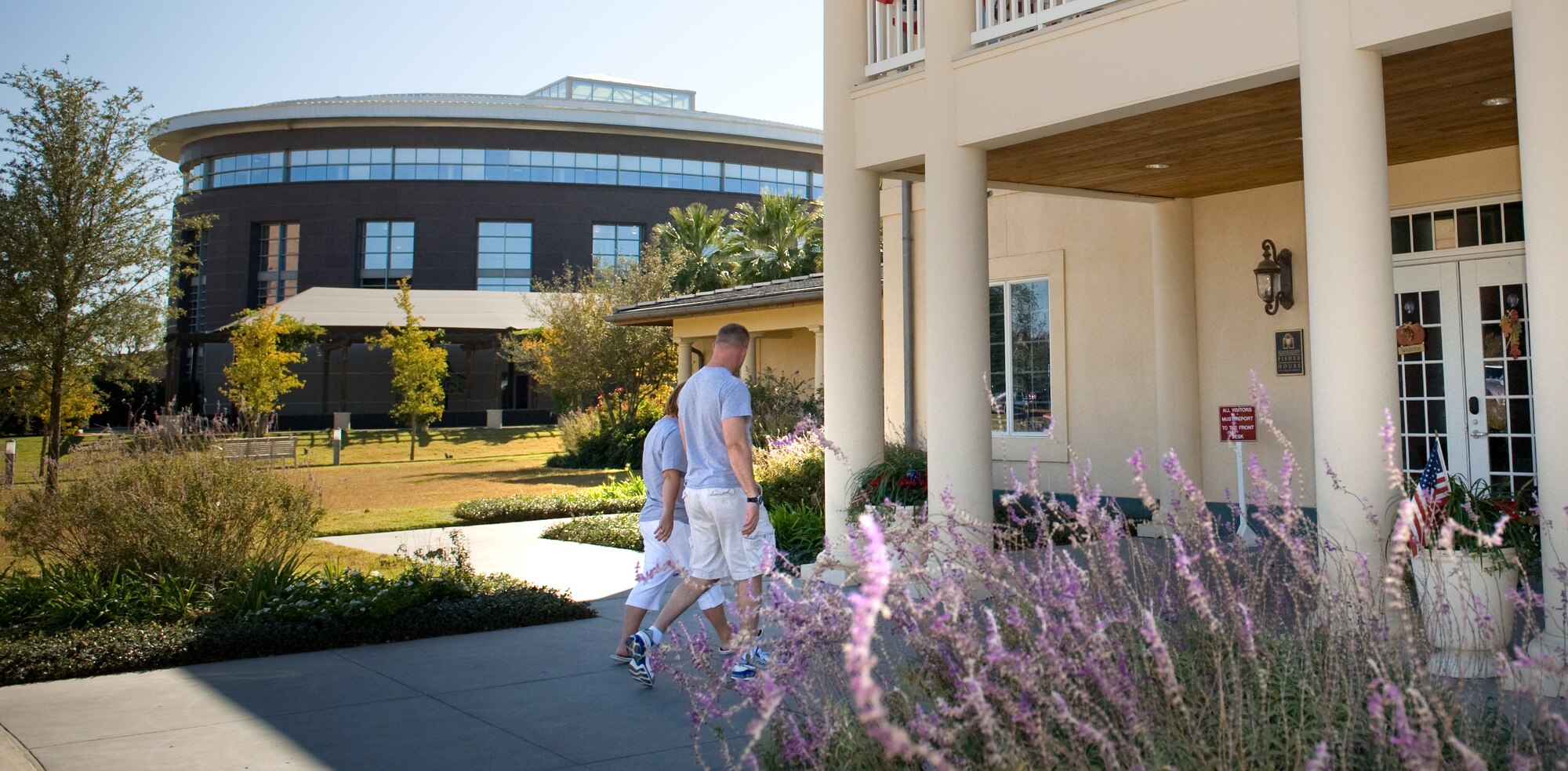 A patient and spouse enter their temporary home in one of the two newest Fisher Houses (right) in San Antonio on Nov. 25.  Each of these 16,800 square foot Fisher Houses can accommodate up to 42 families visiting their injured love ones. Next door is the Center for the Intrepid, a 65,000 square foot rehabilitation center in San Antonio. Private donations were used to fund their construction, operation and maintenance.  (U.S. Air Force photo/Lance Cheung)