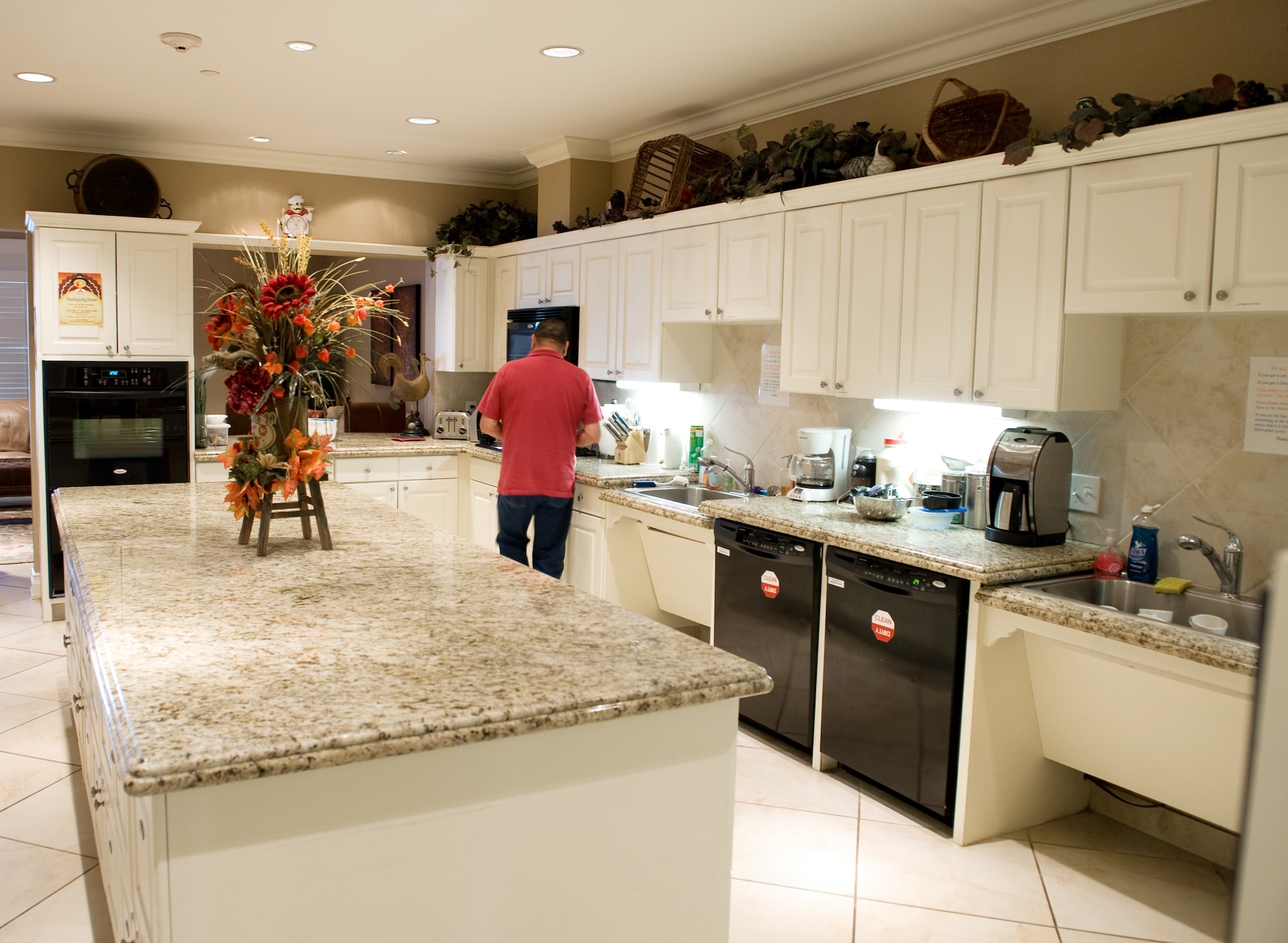 After preparing some food, a patient leaves the kitchen of one of the two newer Fisher Houses in San Antonio, on Nov. 25.  Each of these 16,800 square foot Fisher Houses can accommodate up to 42 families visiting their injured love ones. Private donations were used to fund their construction, operation and maintenance. (U.S. Air Force photo/Lance Cheung)