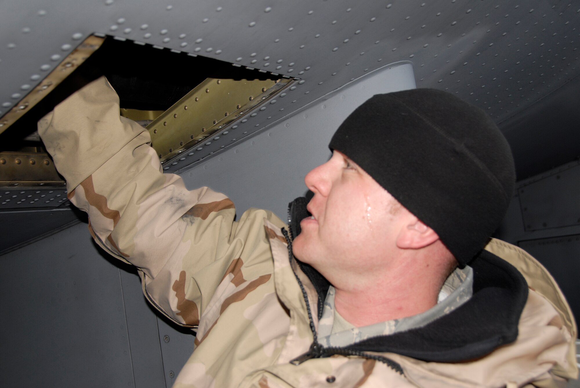 Airmen from the 133rd Airlift Wing work to install a part on a C-130 H3 in Canada. Technical Sgt. Corey Redder, 133rd Maintenance Squadron, installs a replacement valve on a C-130 H3 from the Minnesota Air National Guard. Redder and the crew arriving today in Canada are just returning from the combat zone, and they brought the needed part to the Minnesota C-130 crew on their way to Afghanistan.