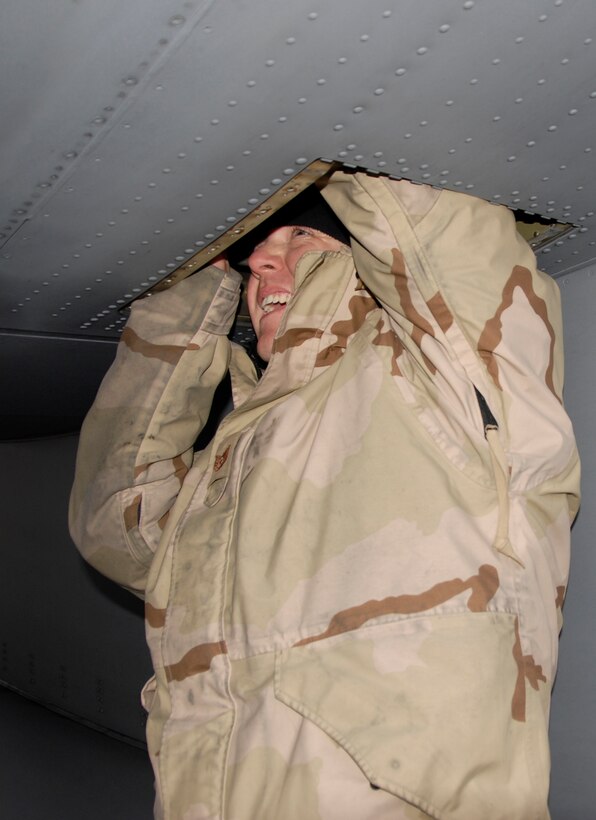 Airmen from the 133rd Airlift Wing work to install a part on a C-130 H3 in Canada. Technical Sgt. Corey Redder, 133rd Maintenance Squadron, installs a replacement valve on a C-130 H3 from the Minnesota Air National Guard. Redder and the crew arriving today in Canada are just returning from the combat zone, and they brought the needed part to the Minnesota C-130 crew on their way to Afghanistan.