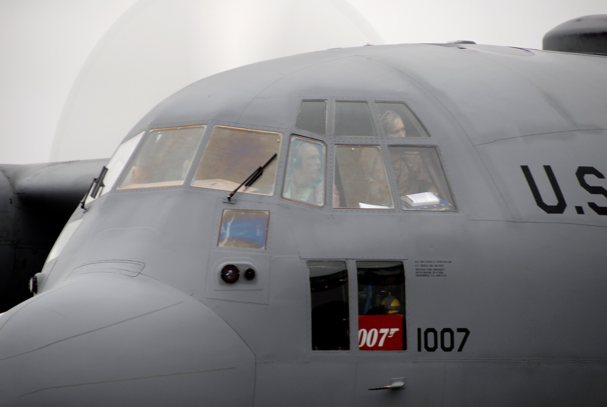 A C-130 H3 "Hercules" from the 133rd Airlift Wing of St. Paul, Minn. lands at a location in Canada, en route from Afghanistan and delivering a part to another C-130 from the Minn. Air National Guard. The second aircraft waits to fly on to Afghanistan.