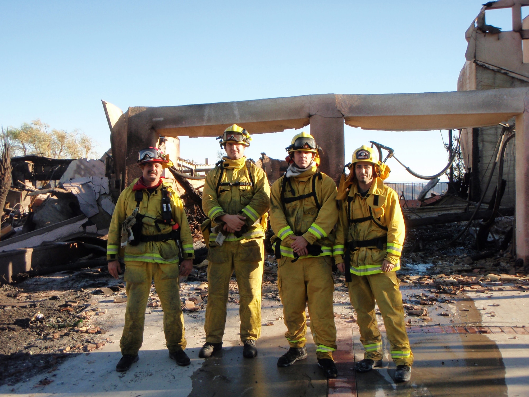 As part of a mutual aid agreement with the local community, March Air Reserve Base (Calif.) Fire Department dispatched one engine and four firemen to support Strike Team 6050A in Riverside County, Calif., Nov. 15, 2008. From left are March ARB's Robert Fox, Michael Goodman, Senior Airman Josh Bauman and Eric Russell. (Courtesy photo)