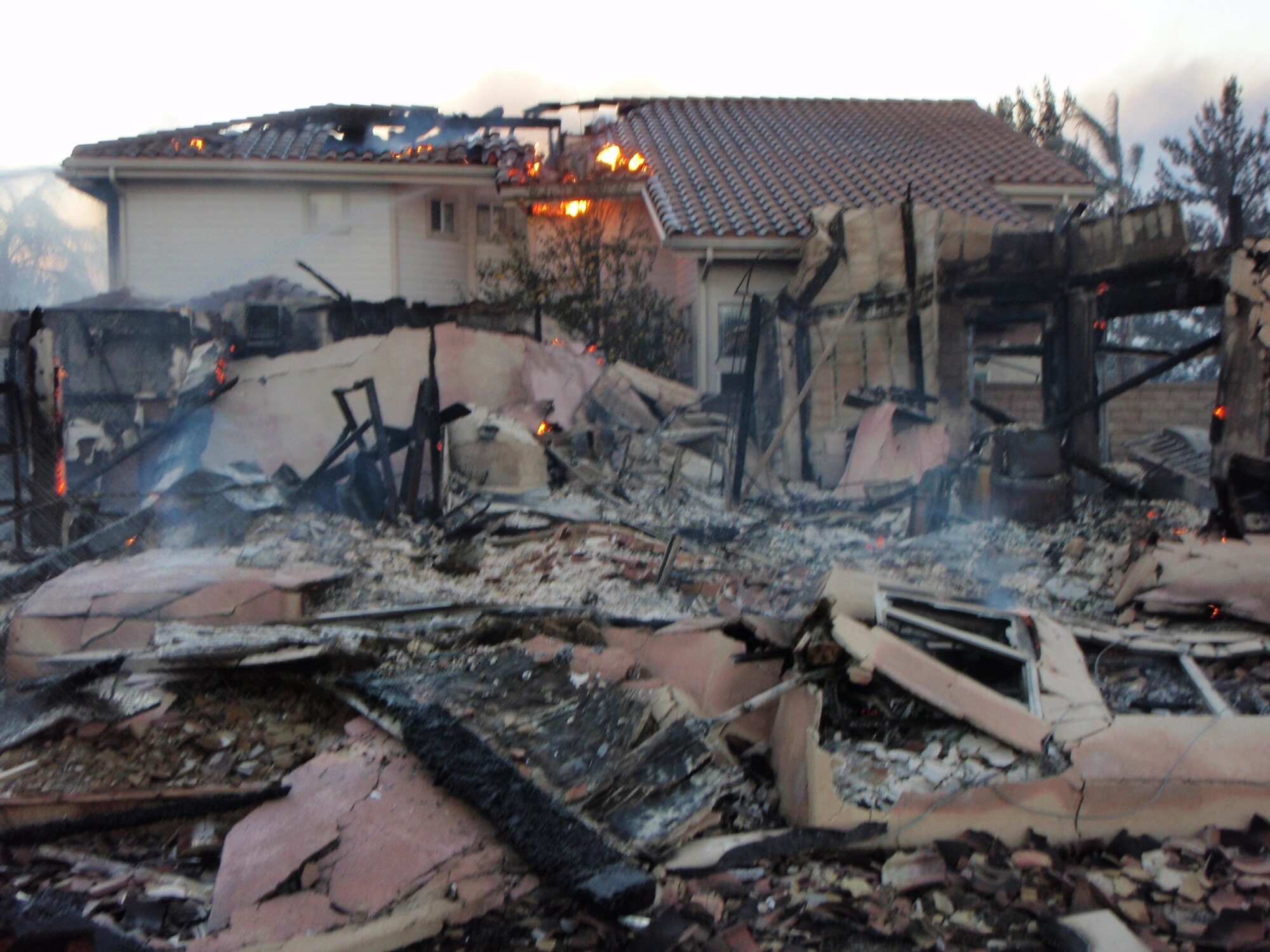 Members of the March Air Reserve Base (Calif.) Fire Department spent most of their time dousing fires at lost homes to prevent hot spots and flare-ups from spreading to neighboring houses after the Freeway Complex Fire on Nov. 15, 2008. (Courtesy photo) 