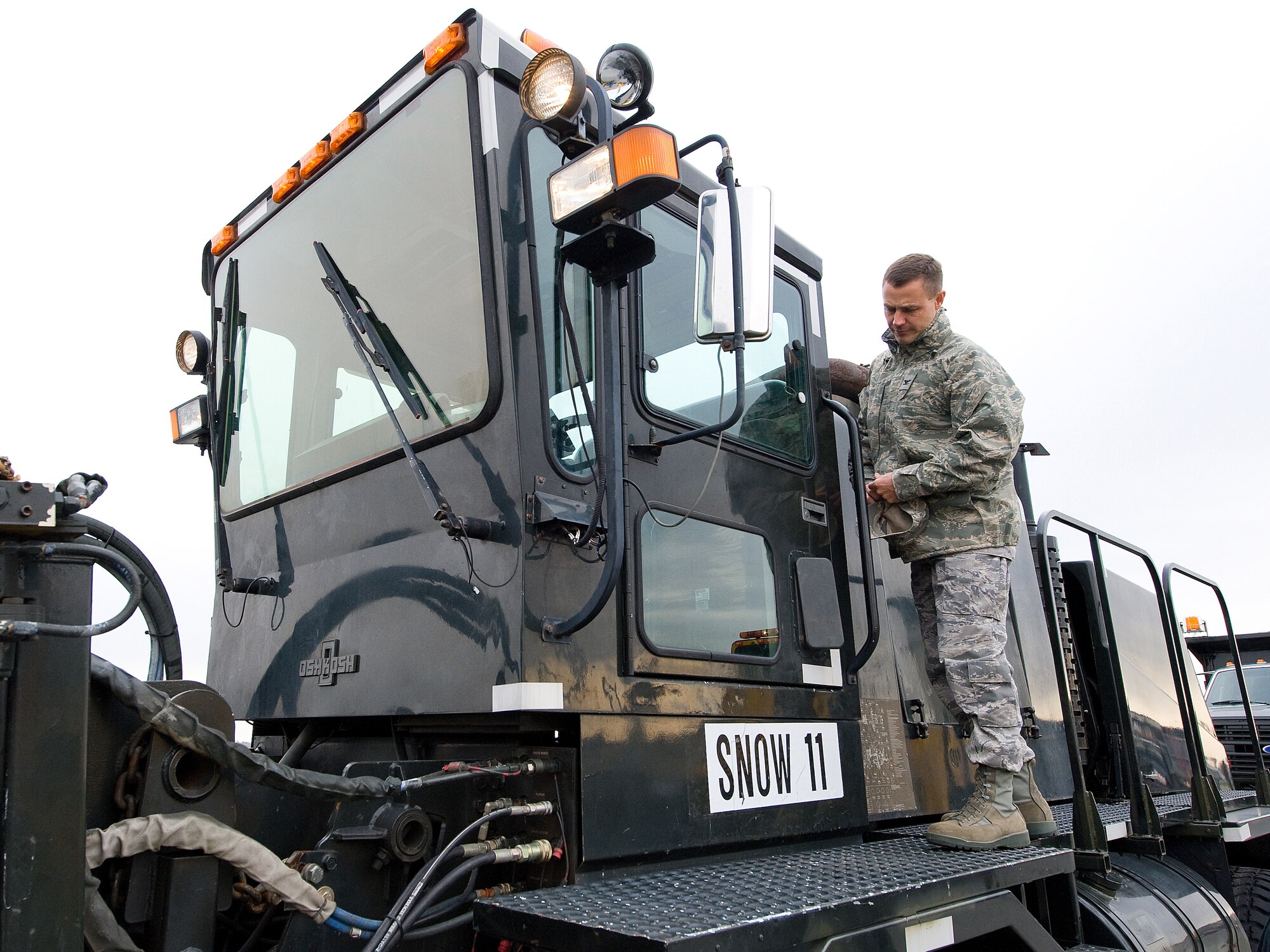 Col. Steven Harrison, 436th Airlift Wing commander, inspects a snow plow before the annual snow plow parade at Dover Air Force Base Nov. 20.  The parade was held to demonstrate the snow plowing capabilities to base leadership before the upcoming winter season.  (U.S. Air Force photo/Tom Randle)