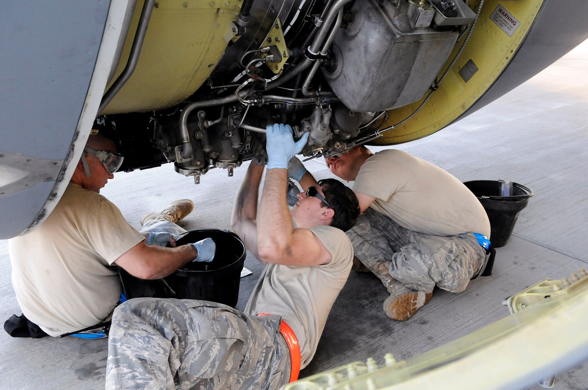 Staff Sgt. Eric Mutschlechner performs a 60-hour inspection as Staff Sgt. Anthony Hernandez and Airman 1st Class Alexander Lesch perform a 120-hour inspection on a KC-135 Stratotanker engine Nov. 20 at an air base in Southwest Asia. KC-135s provide the core aerial refueling capability for the Air Force and support to Navy, Marine Corps and allied nation aircraft in the U.S. Central Command area of responsibility. Sergeant Mutschlechner is a native of San Marcos, Texas, and is deployed from MacDill Air Force Base, Fla. Sergeant Hernandez hails from Barstow, Calif., and is deployed from McConnell AFB, Kan. Airman Lesch is from Burlington, Wis., and deployed from Grand Forks AFB, N.D. All three are assigned to the 379th Expeditionary Aircraft Maintenance Squadron. (U.S. Air Force photo/Tech. Sgt. Michael Boquette) 

