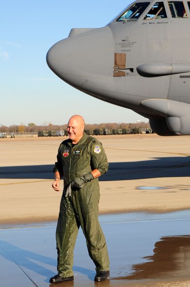 BARKSDALE AIR FORCE BASE, La.- Col. West Anderson, 2d Bomb Wing Vice Commander, smiles at his family after being sprayed with a fire hose, following his "fini" flight Nov. 25. Colonel Anderson is leaving the Wing to be the Director of Staff at 8th Air Force.  The tradition of the "fini" flight dates back to the Vietnam War when pilots would celebrate their 100th flight with champagne. This flight totals over 3,216 flying hours for Colonel Anderson.(U.S. Air Force photo by Senior Airman Joanna M. Kresge)