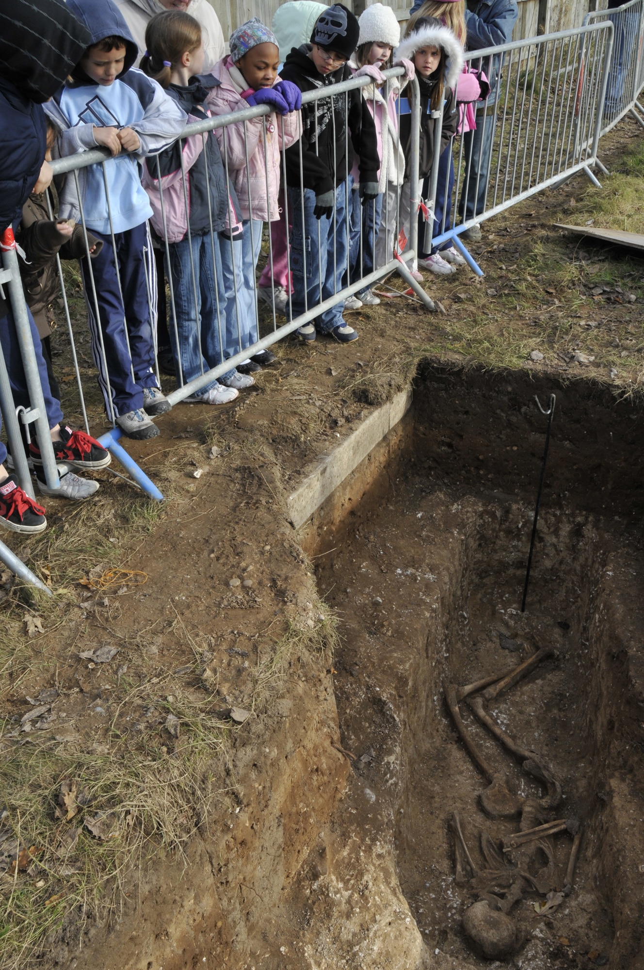 Elementary students look in awe at the 2,000 year old graves Nov 21 at RAF Lakenheath, England. The Suffolk County Council Archaeological Service community liaison has conducted over 20 tours for Lakenheath school children. (U.S. Air Force photo by Airman 1st Class Perry Aston)