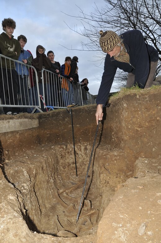 The Suffolk County Council Archaeological Service community liaison points out the pendent that was found on a skeleton Nov 24 at RAF Lakenheath, England. He has conducted over 20 tours for Lakenheath school children. (U.S. Air Force photo by Airman 1st Class Perry Aston) 