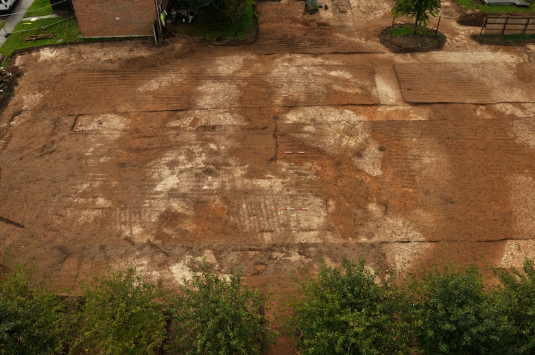 When a housing unit at RAF Lakenheath, England, was torn down, construction workers found signs of an ancient ?ring ditch burial mound,? the outline of the mound can be seen through the darker areas in the picture. When construction workers saw this, they contacted the 48th Civil Engineering Environmental flight, who then coordinated the archaeological dig with the Suffolk County Council Archaeological Service. Five human skeletons dating back to periods between the Bronze and Iron age were found in the ditch surrounding the mound. (U.S. Air Force photo by Airman 1st Class Perry Aston) 